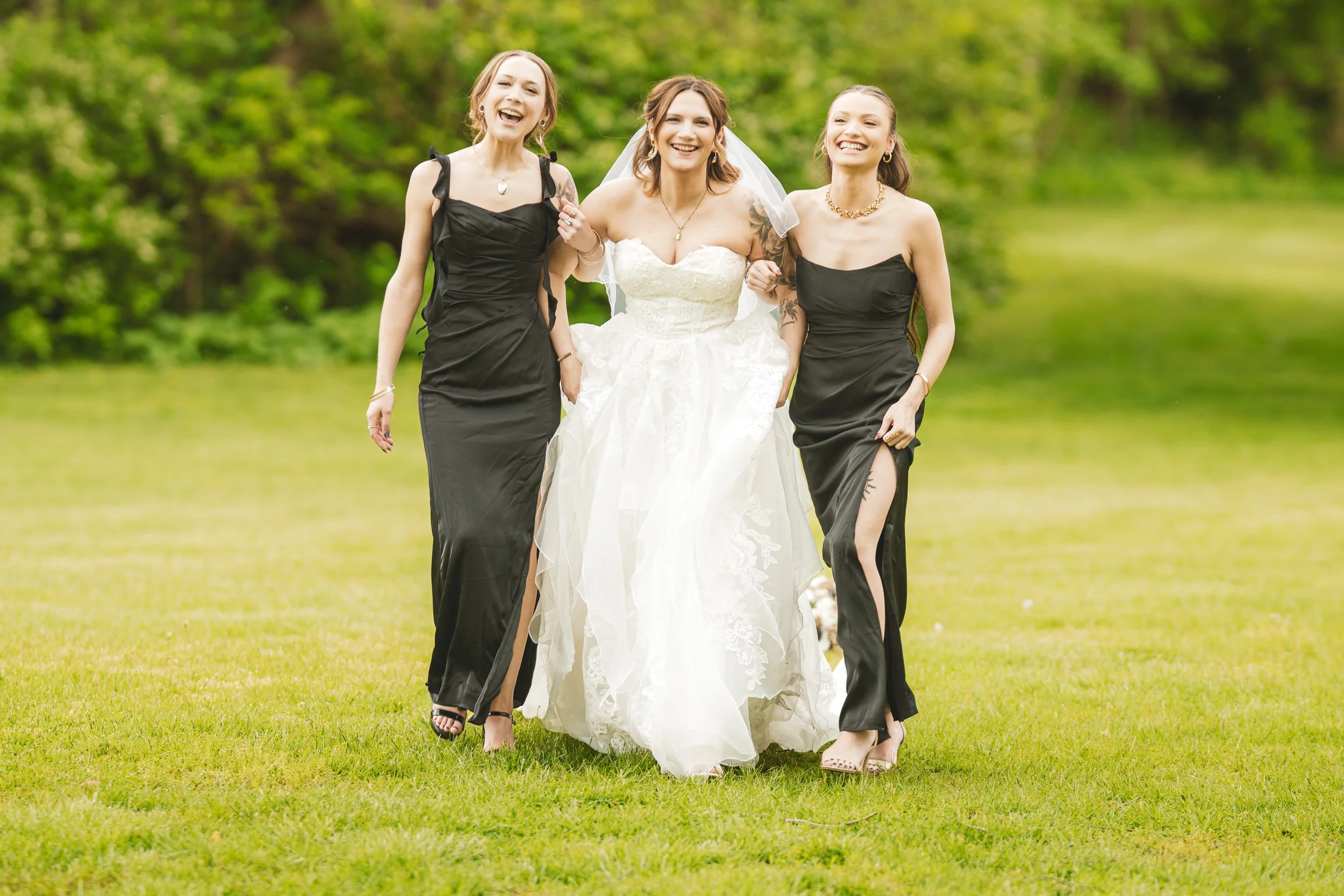 A fun moment between friends and bridesmaids at a wedding at Deep River County Park.