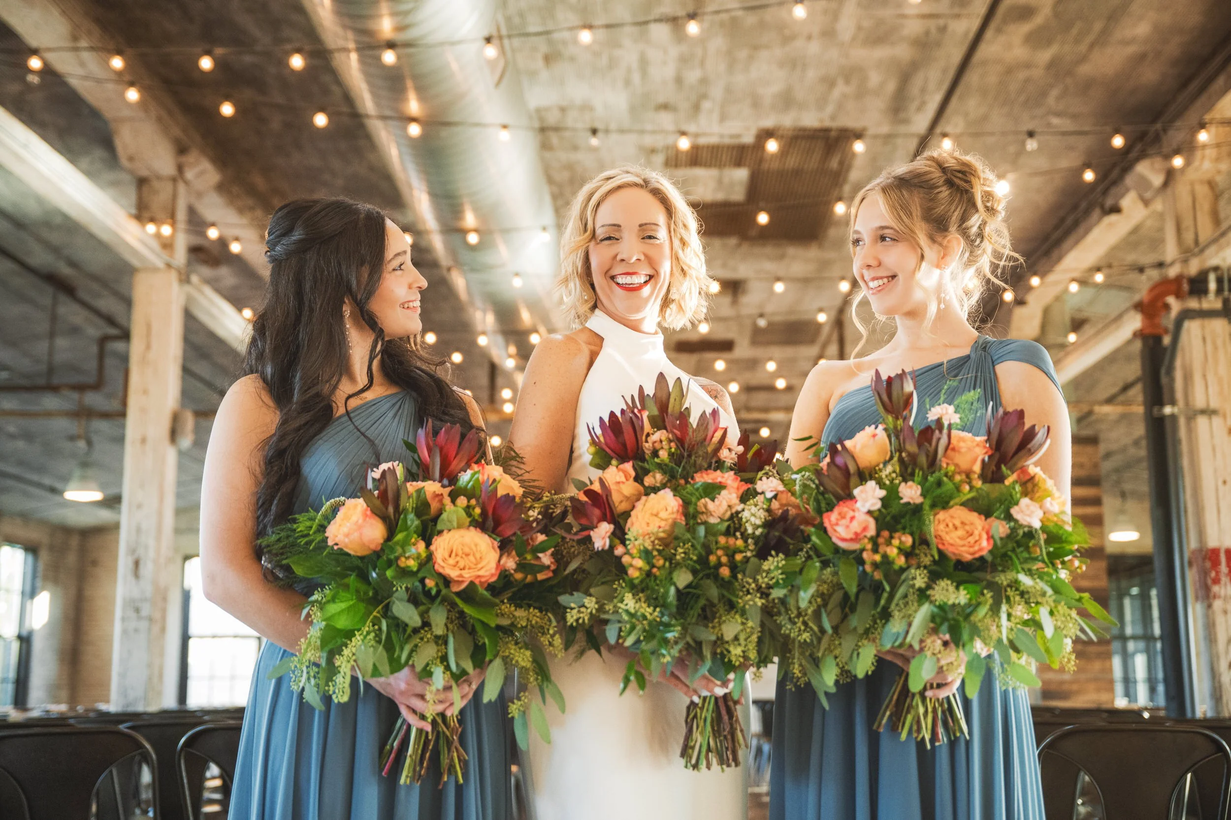 A bride with her bridesmaids who are also her daughters.