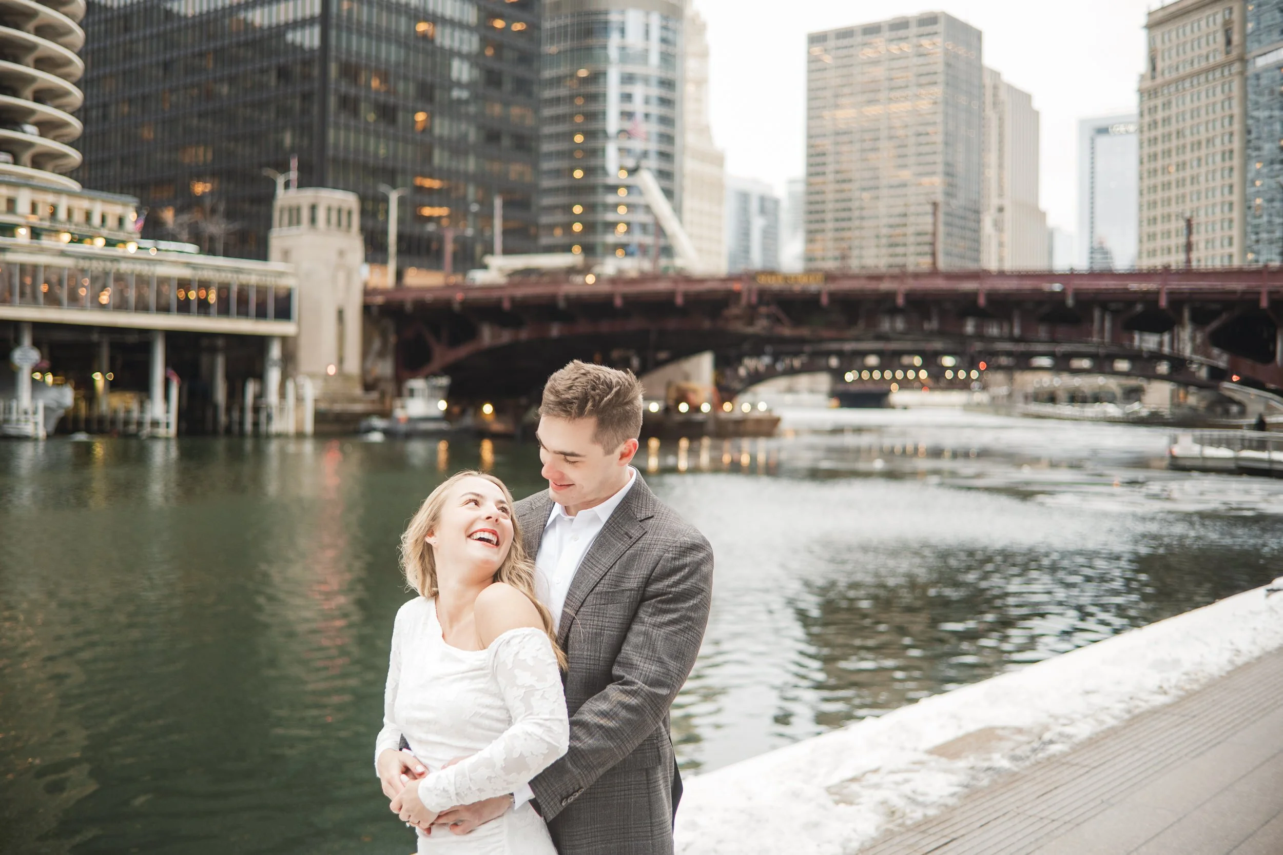 A candid moment during an engagement session on the Chicago Riverwalk during the winter.