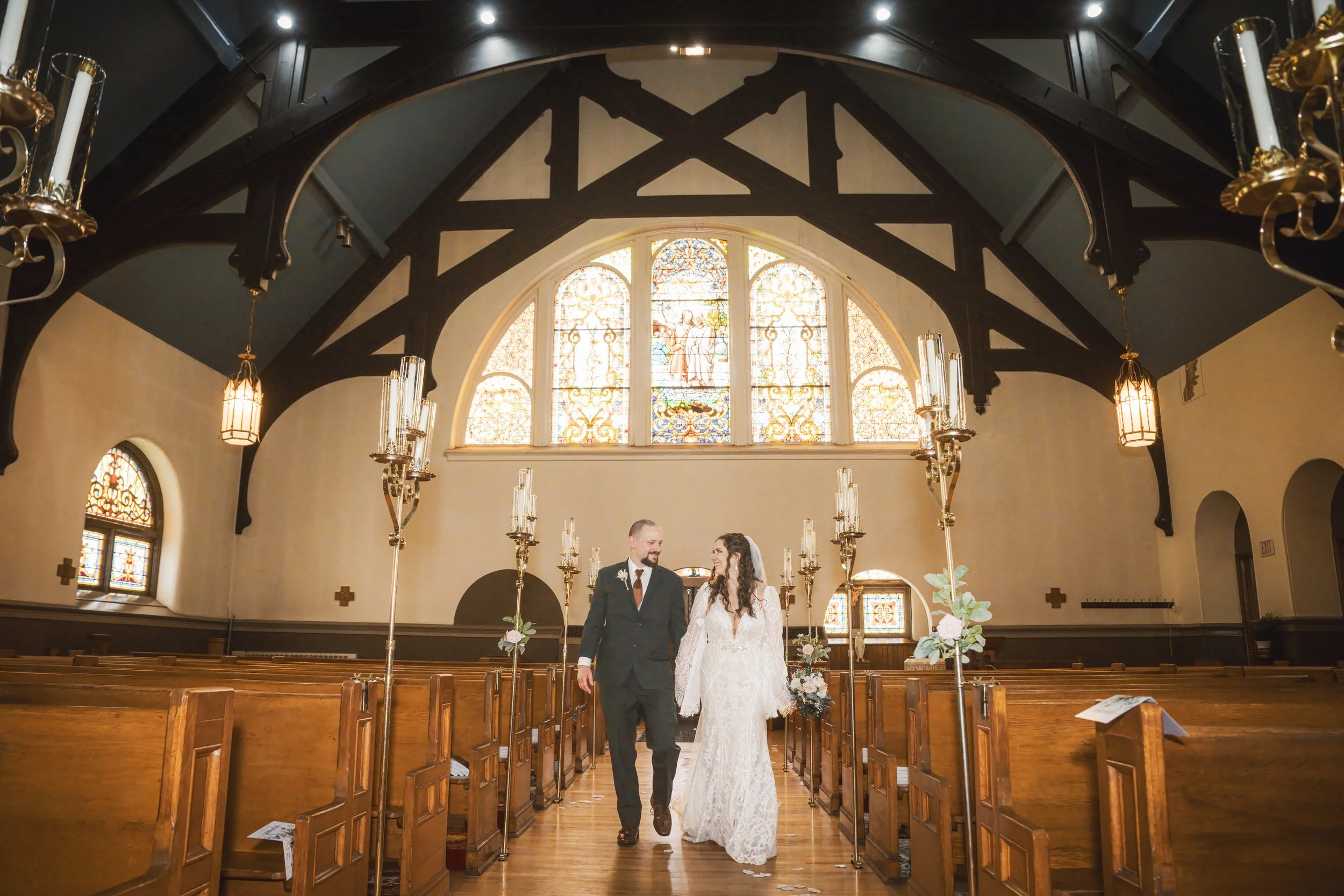 Bride and groom walk down the aisle of Trinity Church in Michigan City, Indiana.