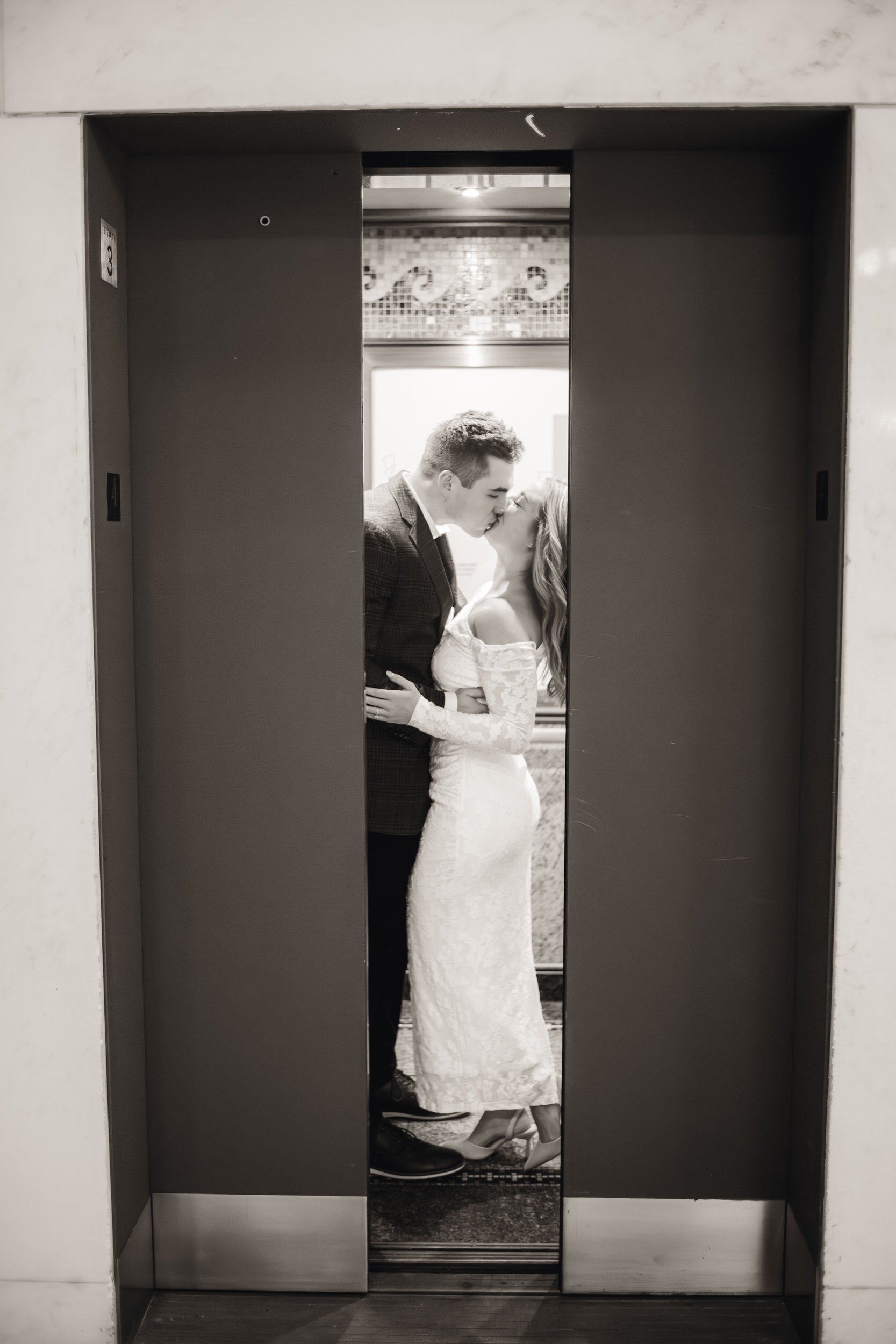 A romantic kiss inside an elevator during a Chicago engagment photo session.