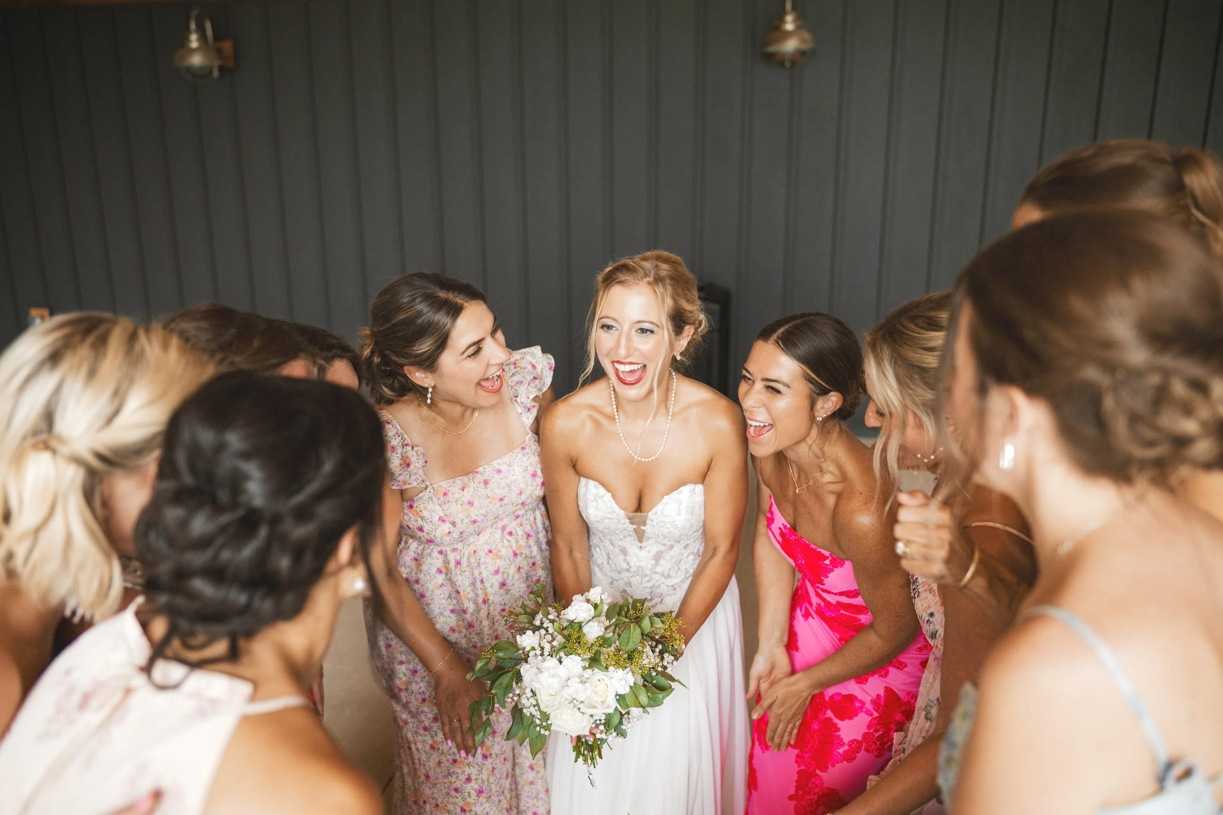 The bride gets cheered on by her friends in a football huddle.