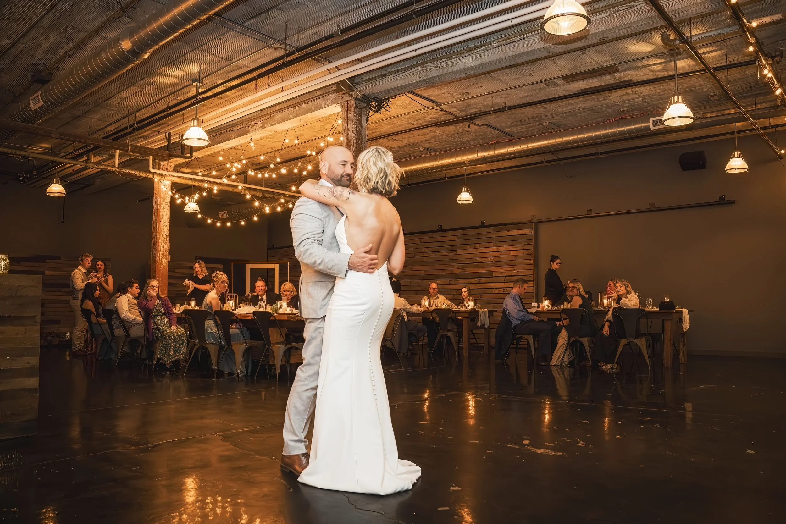 First dance of the bride and groom during an intimate wedding reception at Journeyman Distillery.