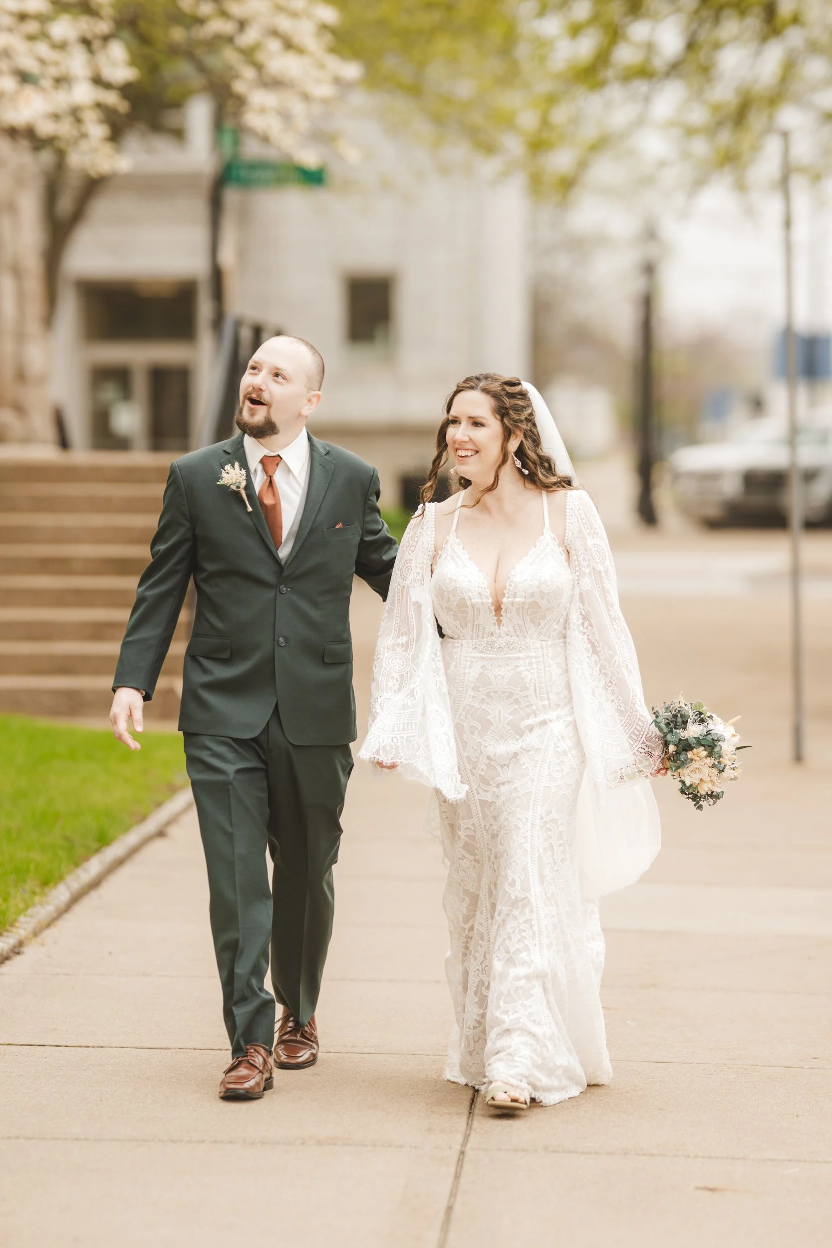 Bride and groom walk away from Trinity Church in Michigan City, Indiana.