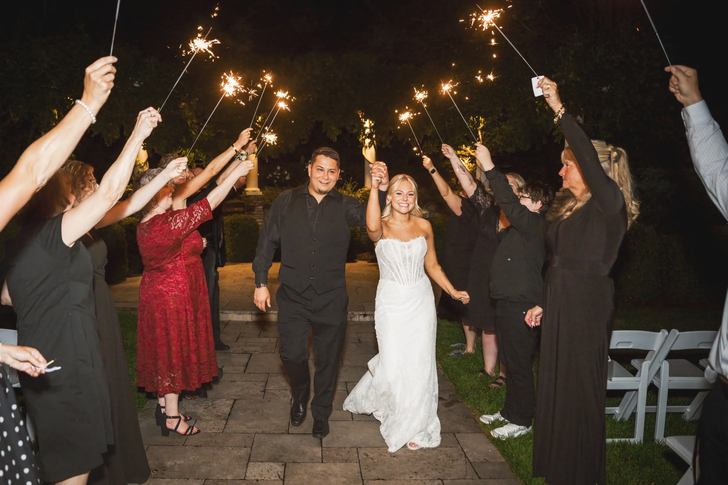 The bride and groom have a sparkler exit at their wedding reception at The Pavilion at Sandy Pines.