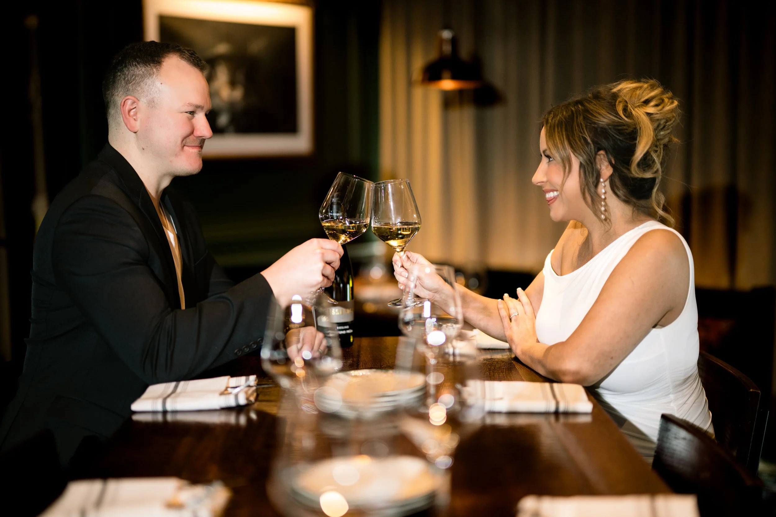A newly engaged couple celebrate with champagne.