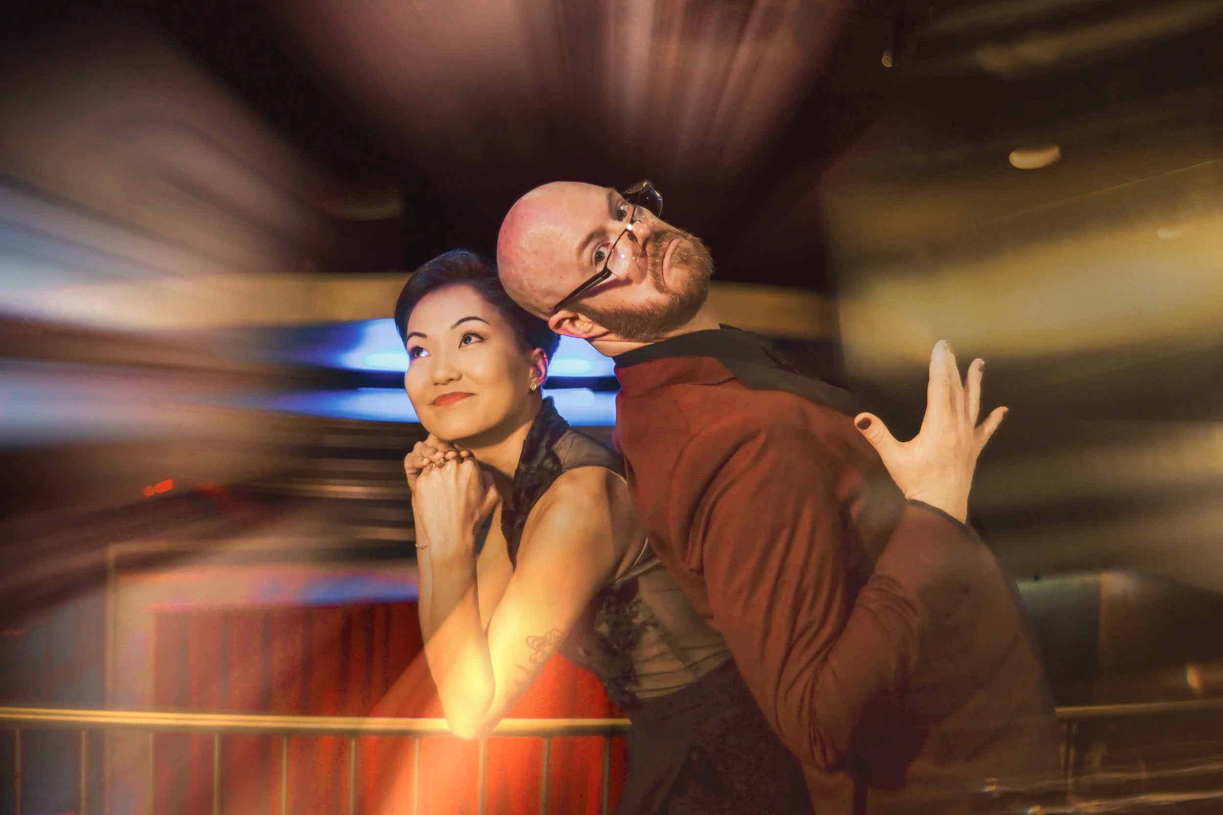 The bride and groom act goofy in a fun wedding photo at their Chicago wedding inside a speakeasy.