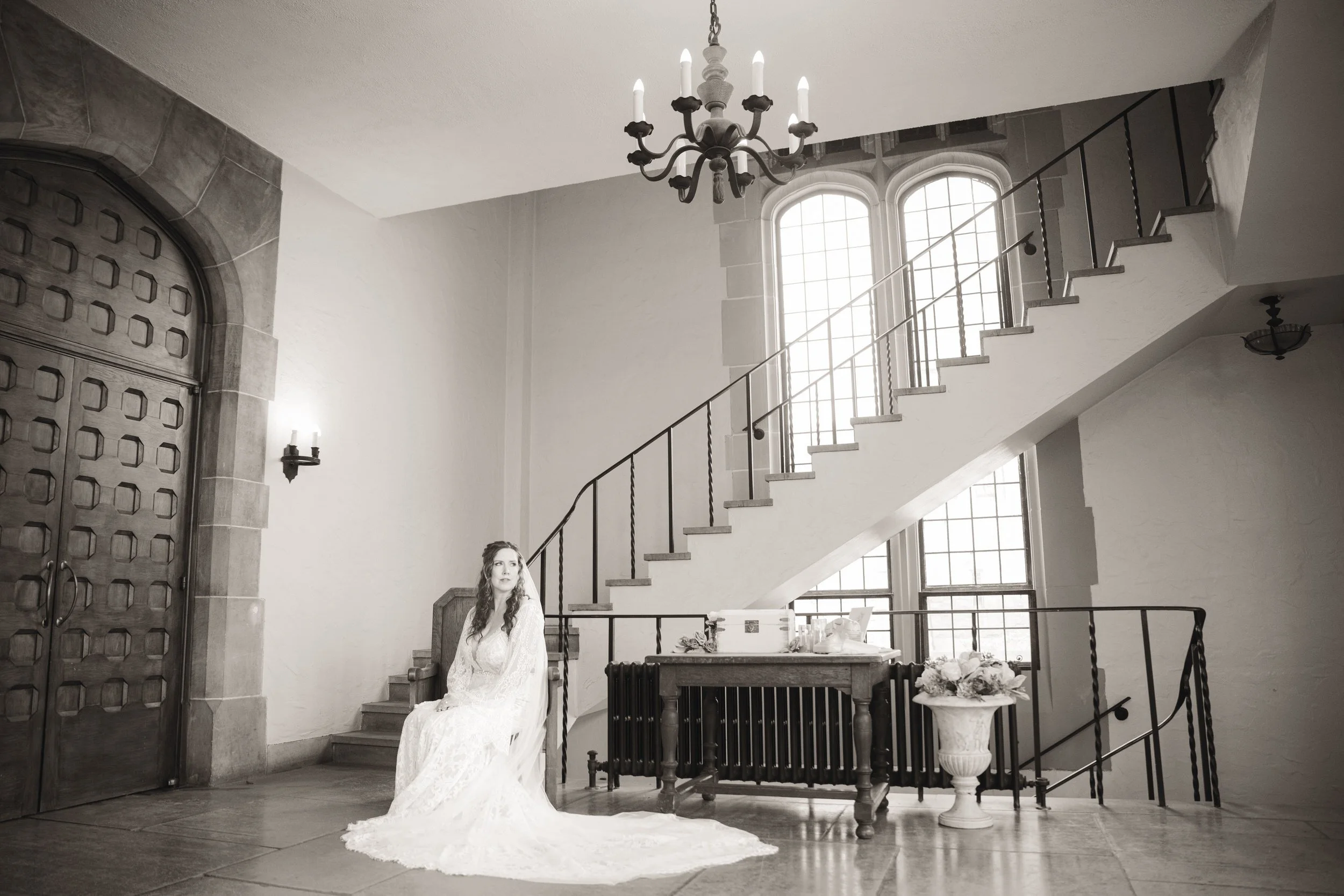 An elegant wedding photo of a bride sitting in the lobby of Barker Hall at Trinity Church in Michigan City, IN.