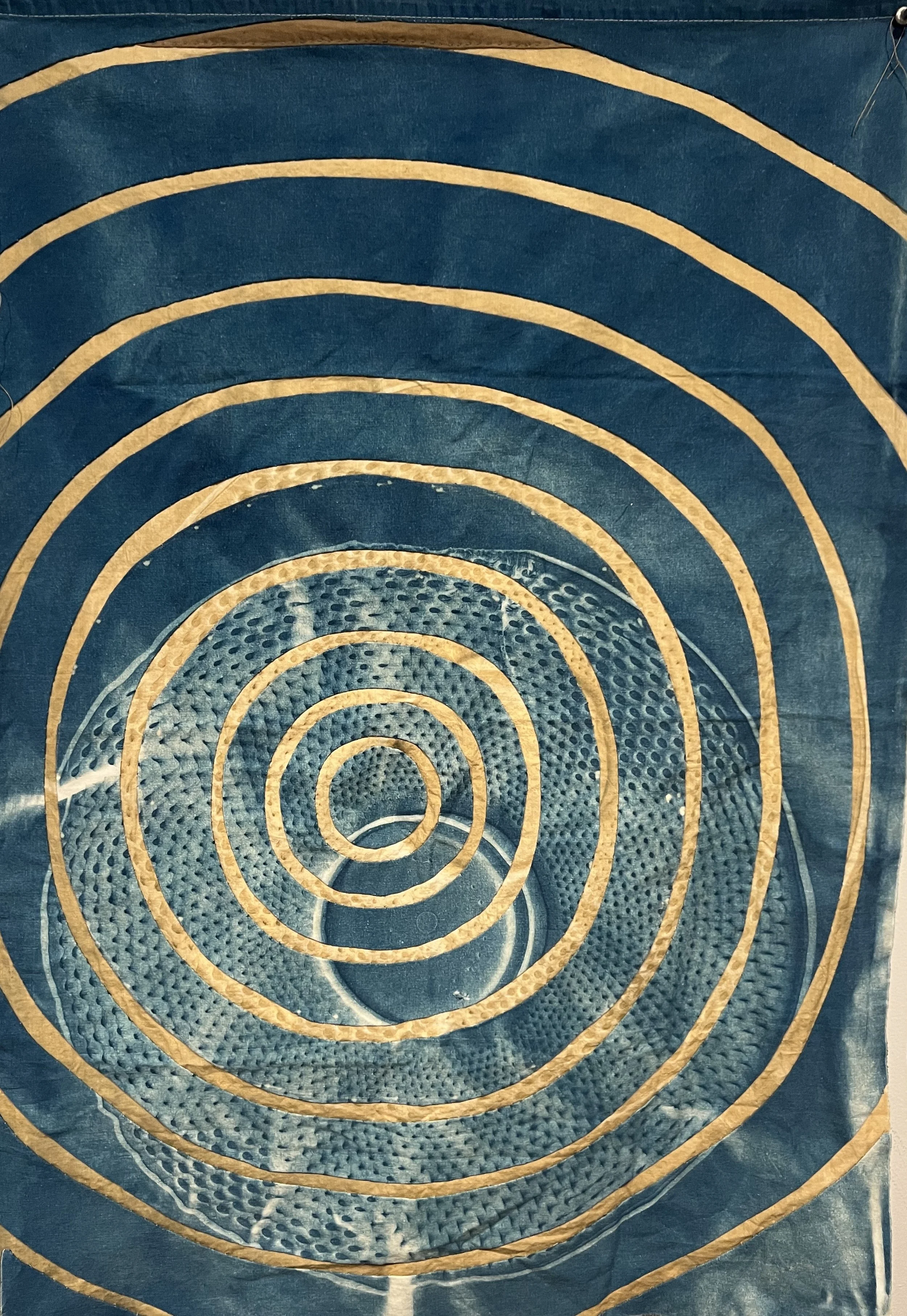   Concentric Circles: Sonar,  2025, cyanotype and bleached cyanotype on upcycled linen and cotton, approximately 32” H x 23” W 
