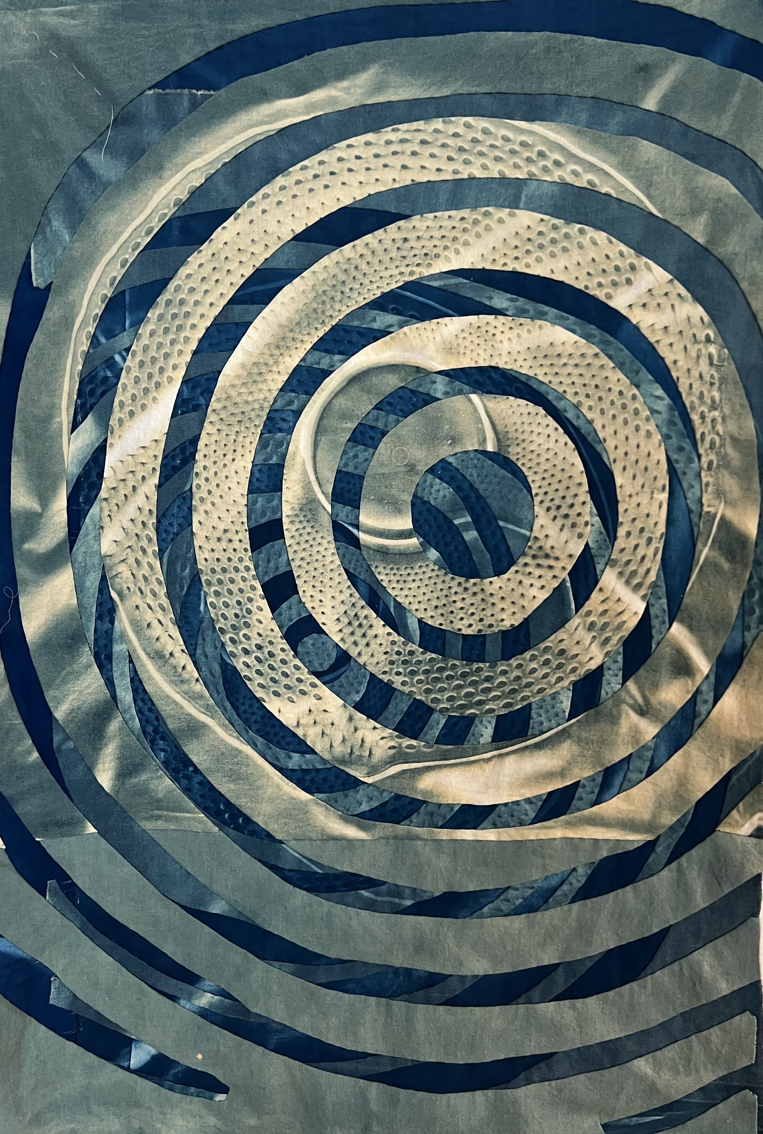    Concentric Circles: Singing Under Everything   ,  2025, cyanotype and bleached cyanotype on upcycled linen and cotton, approximately 32” H x 23” W 