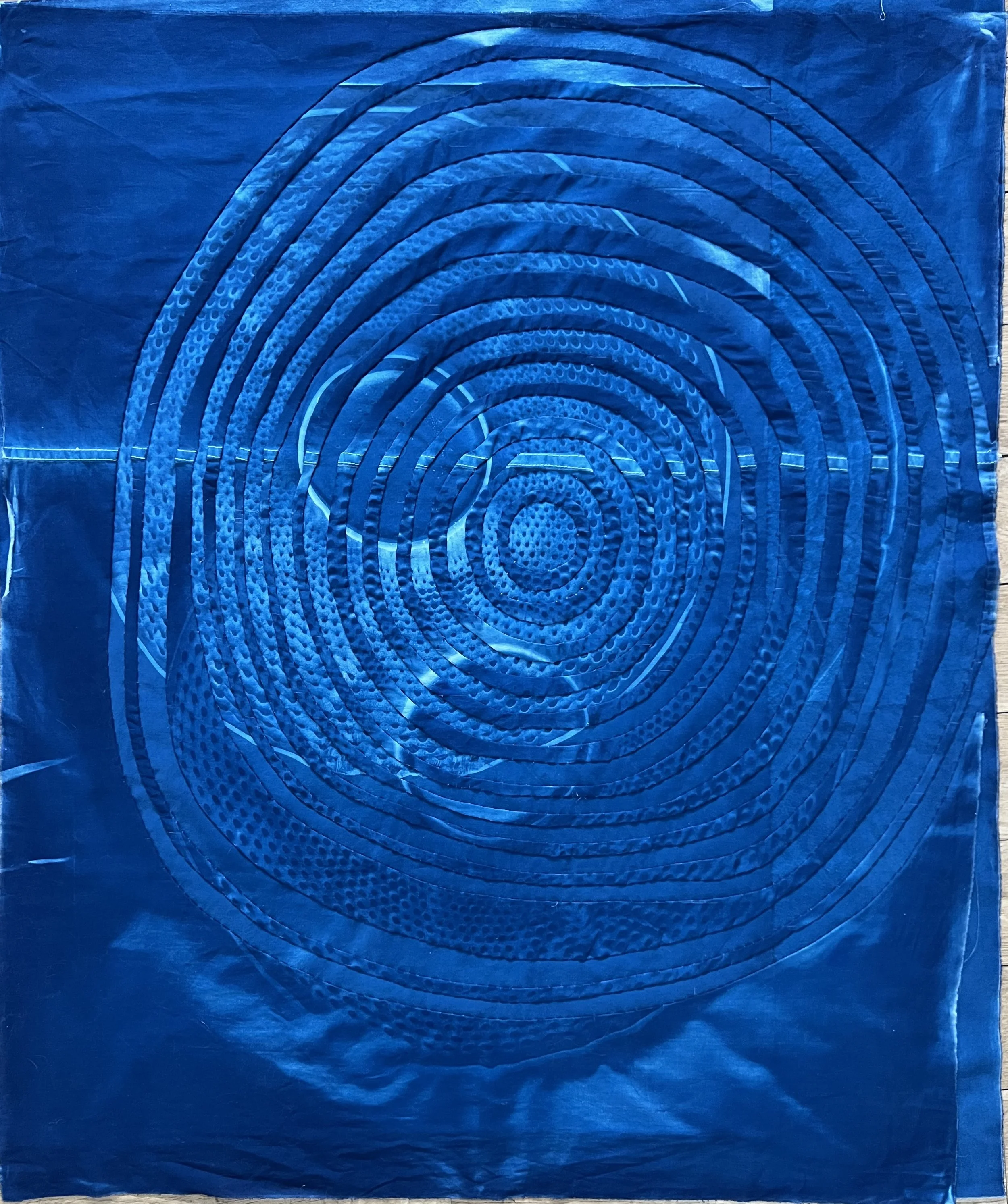    Concentric Circles: Submersive   ,  2025, cyanotype on upcycled cotton, approximately 34” H x 24” W 