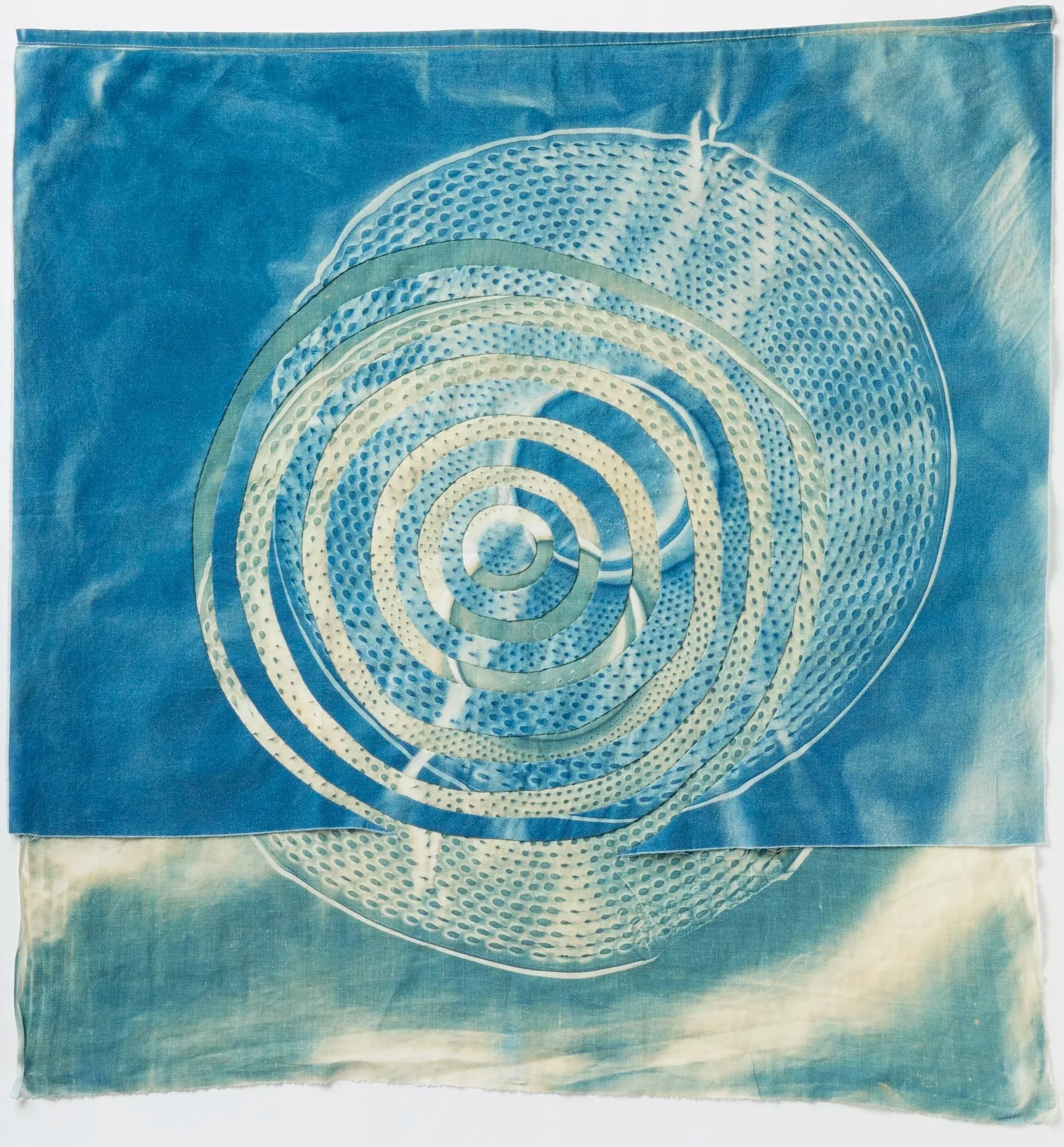   Concentric Circles: Not Fixed, But Sliding   2026  Cyanotype and bleached cyanotype on upcycled linen and cotton  Approximately 28" H x 28 " W   Photo:  Clarissa Bonet 