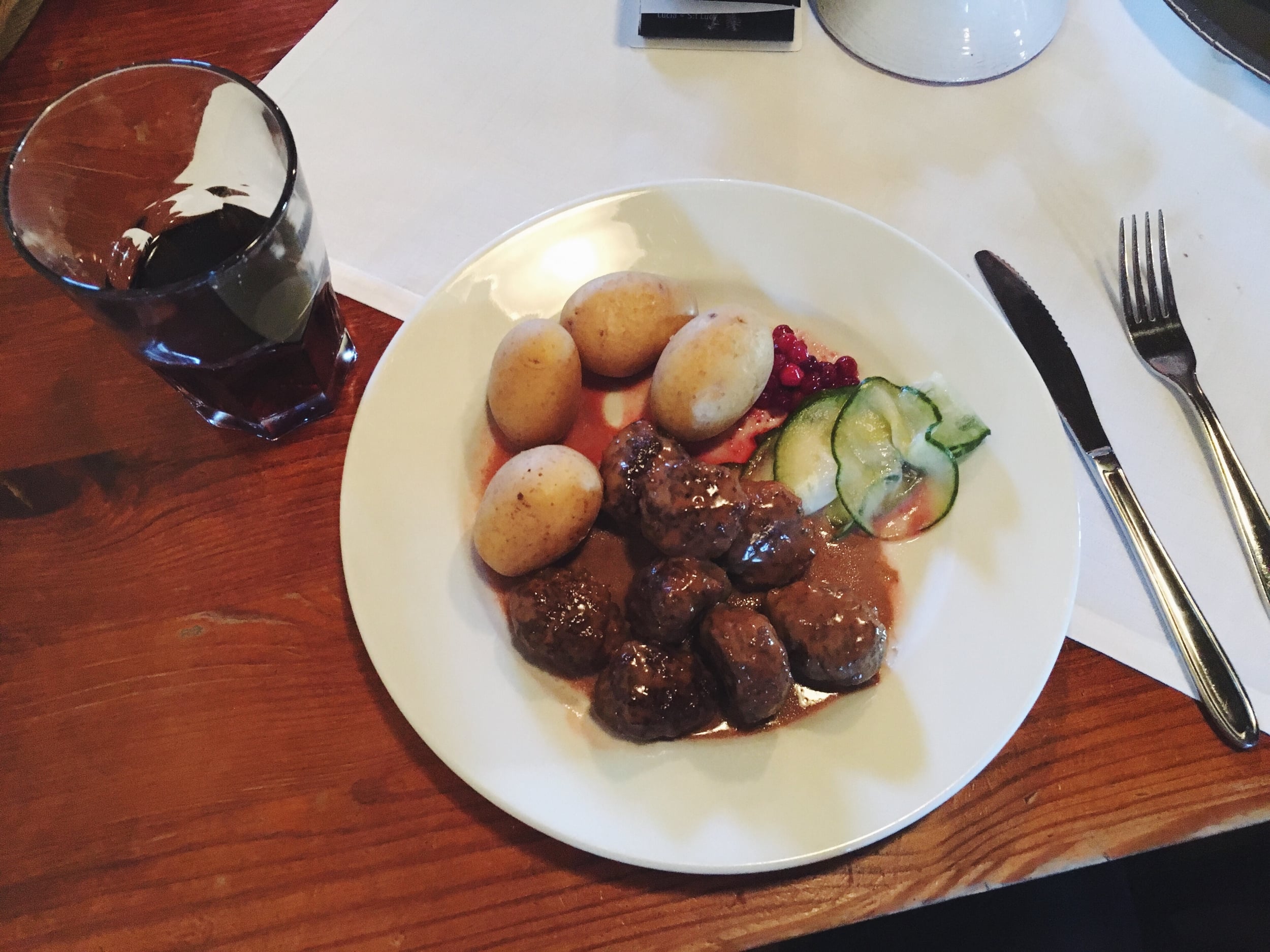 Swedish meatballs with potatoes, pickles, and lingonberries.