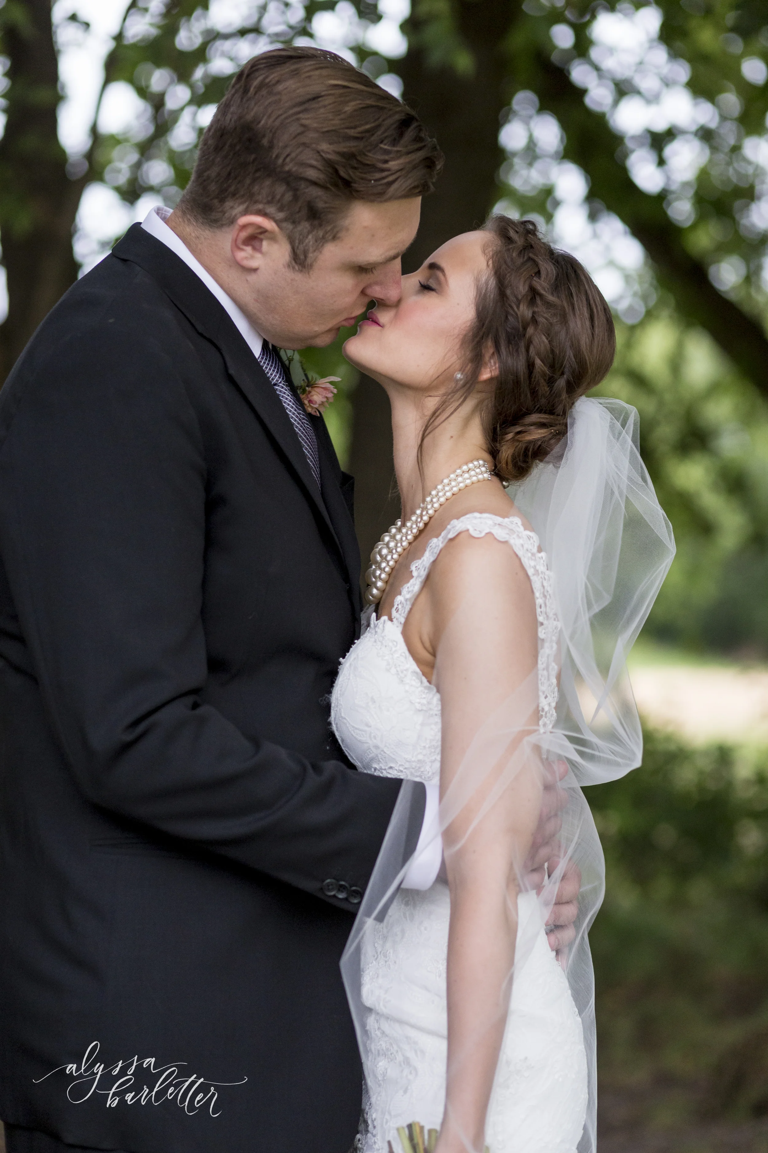 kansas city wedding budget mahaffie bride groom kiss portraits veil