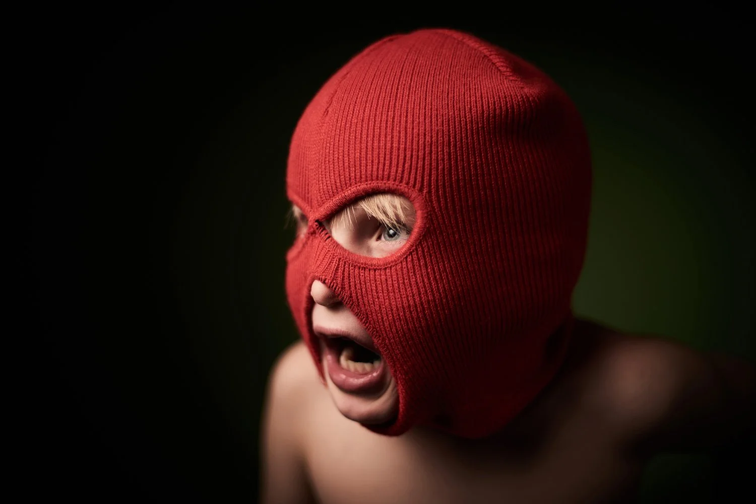  A portrait of a young boy wearing a ski mask photographed in Grand Rapids. 