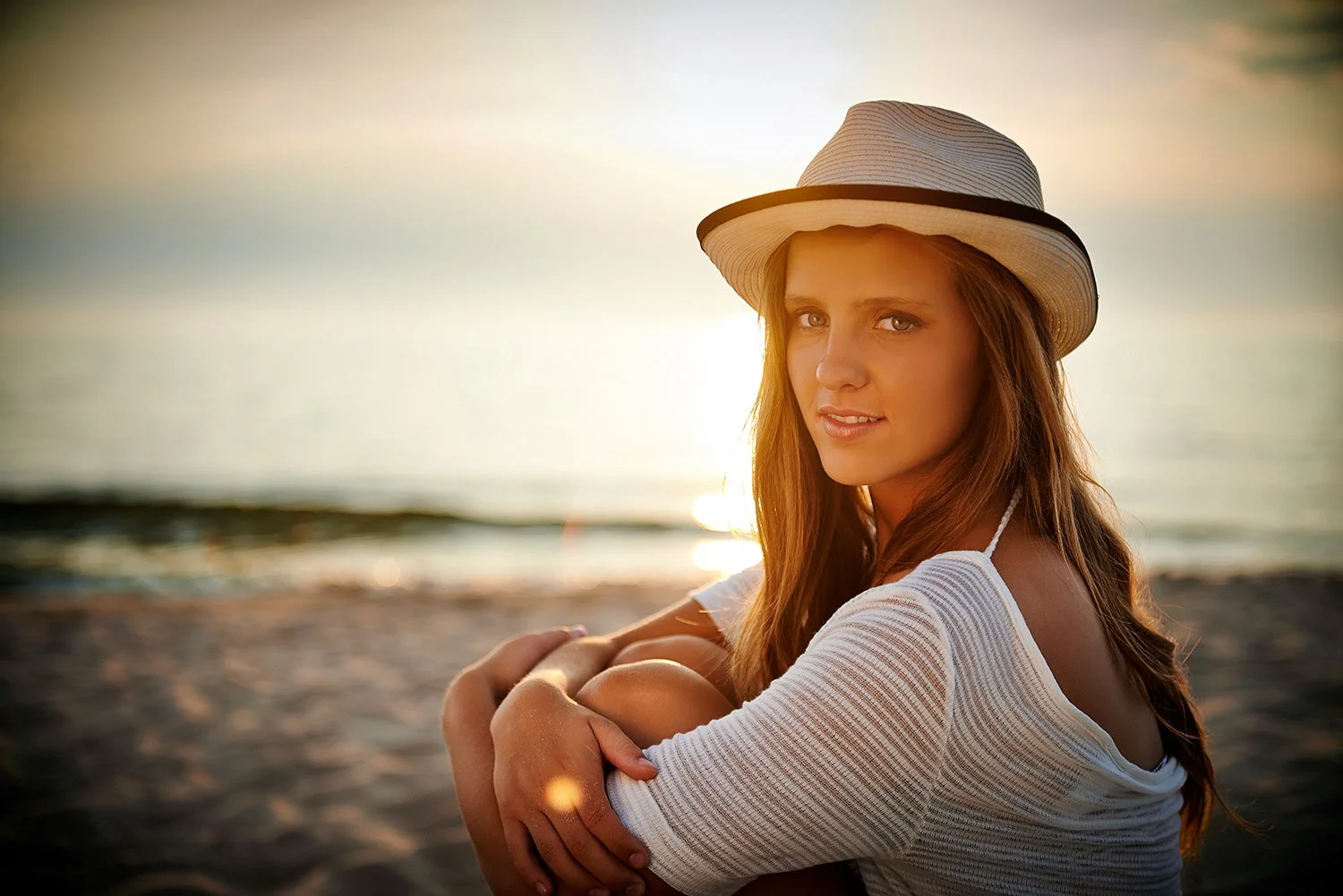  A young model posing for a portrait at the beach. 