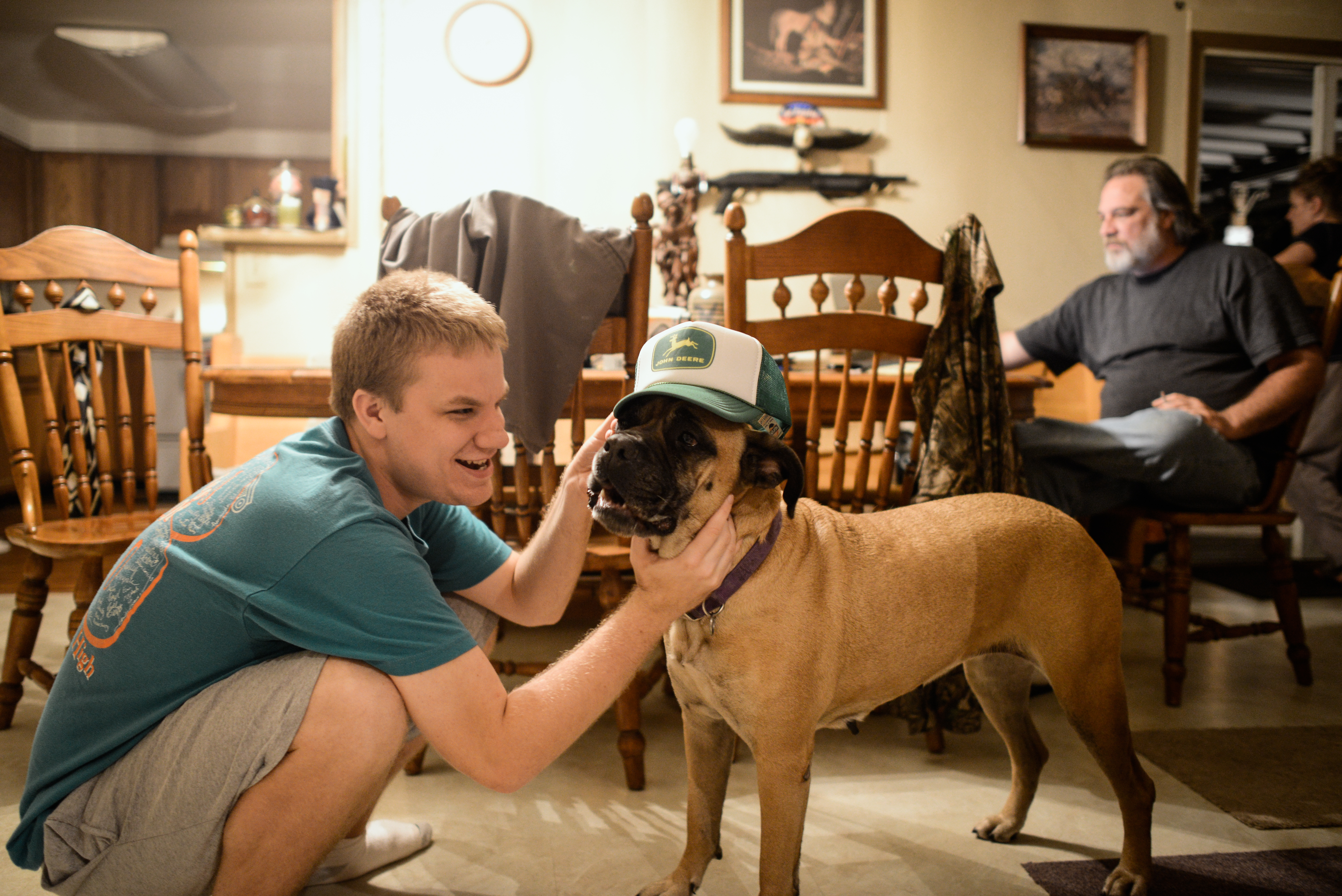  Trenton, Missouri. 2013.  Dalton shares a playful moment with his family dog, Roxy. The family dogs are a source of comfort for him. 
