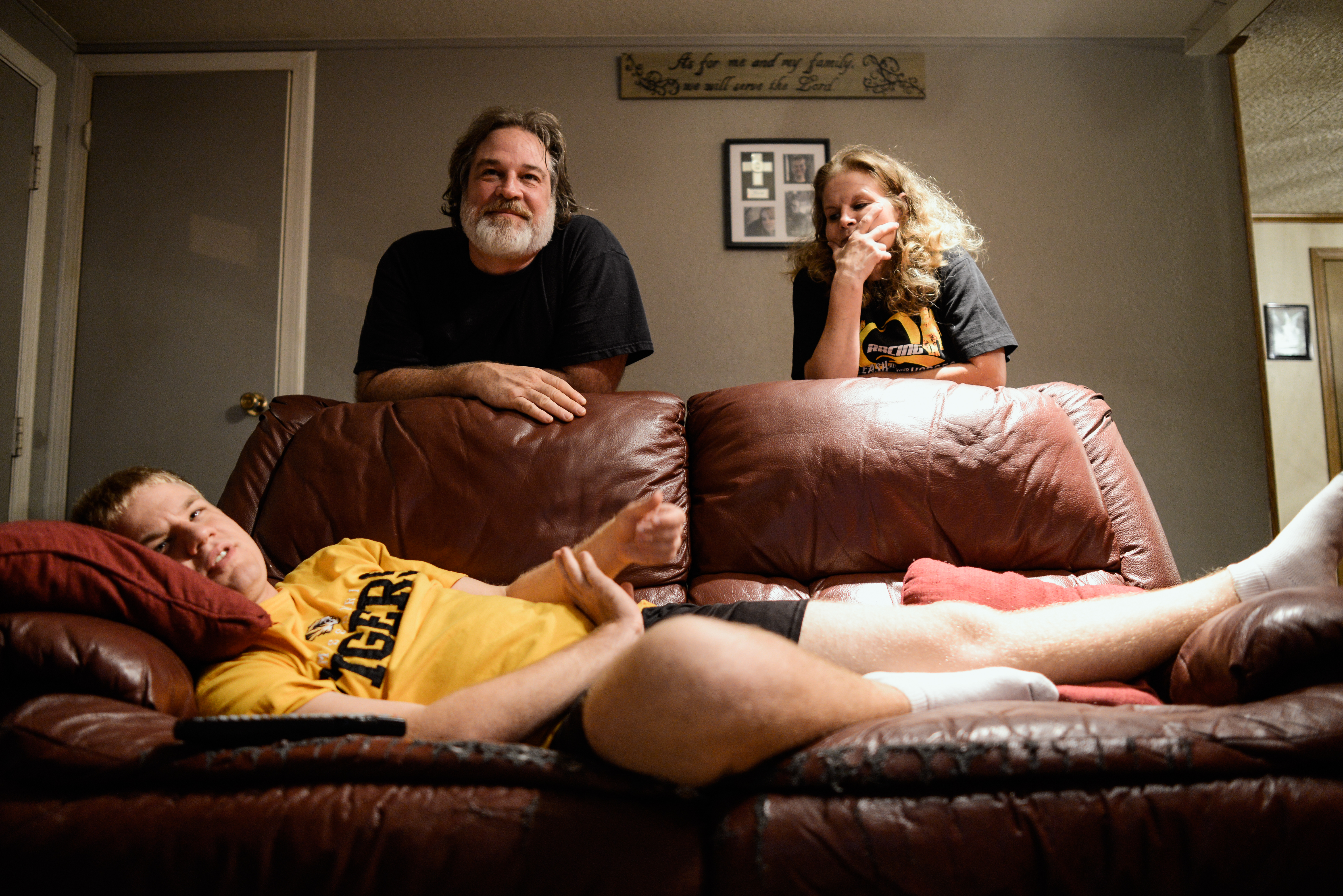  Trenton, Missouri. 2013.&nbsp;  A nightly ritual, Dalton and his parents, Casey and Joyce, spend some time together watching television. 