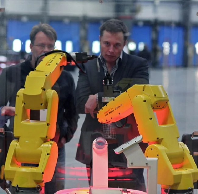 Steve Jurvetson took this picture of what I can only assume are robots bowing down to Elon.