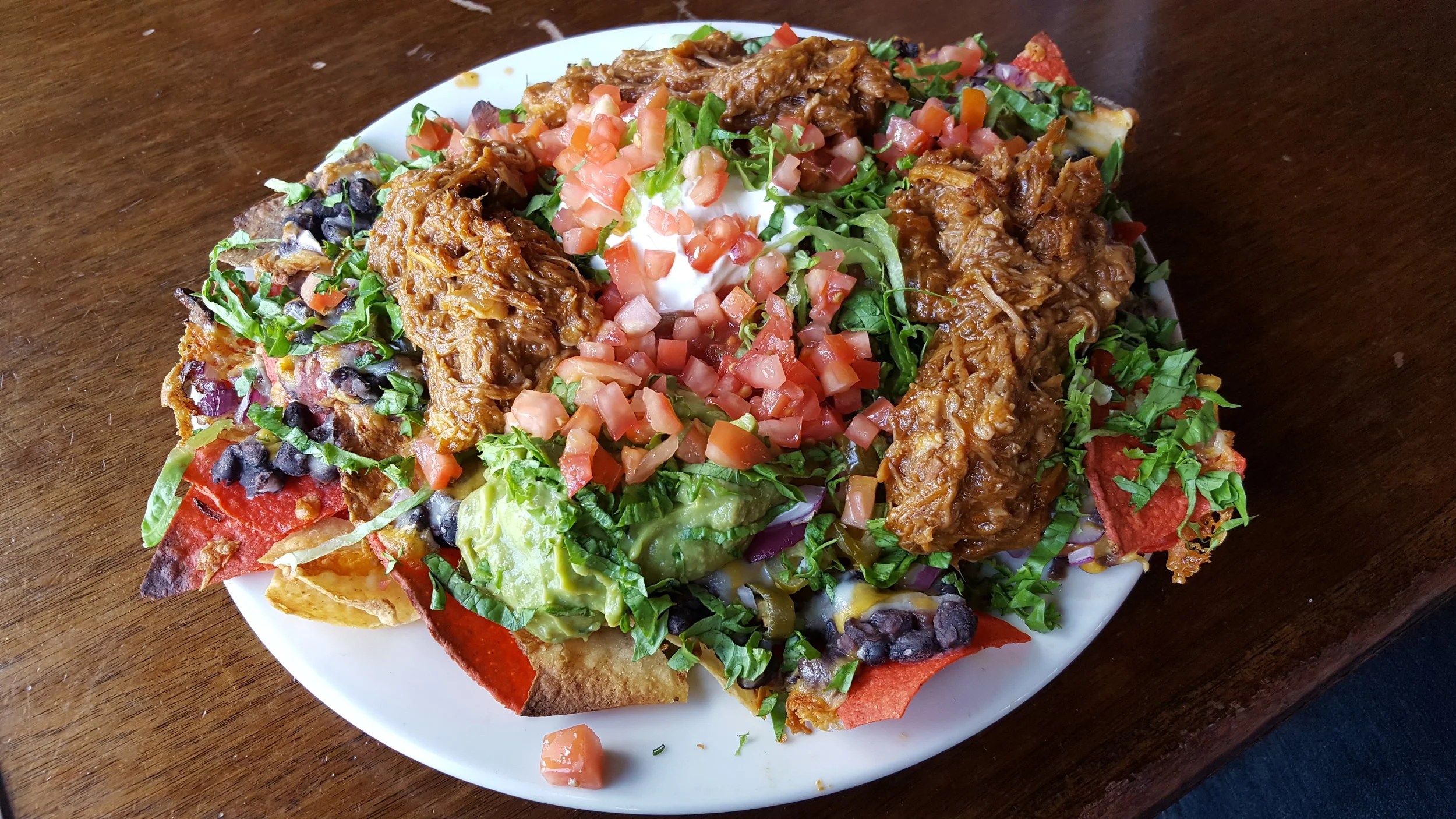 Corn Tortillas, Black Beans, Sour Cream, Monterey Jack & Colby Cheddar, Tomatoes, Lettuce, Salsa, Pulled Pork, Guacamole, Onions, Jalapenos