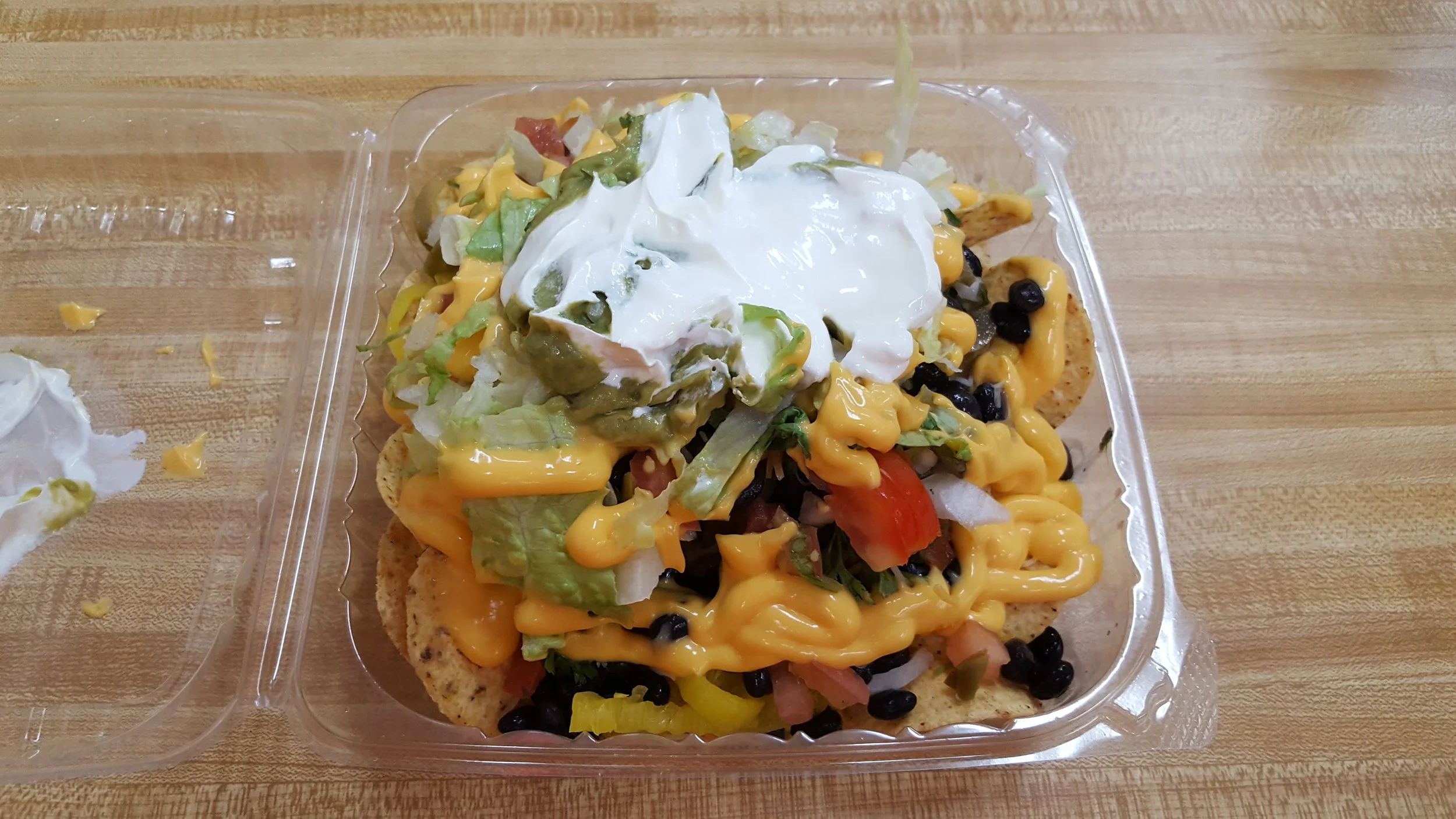 Pulled Pork + Chorizo, Shredded Cheese, Nacho Cheese, Black Beans, Pico de Gallo, Onions, Jalapenos, Banana Peppers, Tomatoes, Lettuce, Sour Cream, Guacamole, Cilantro