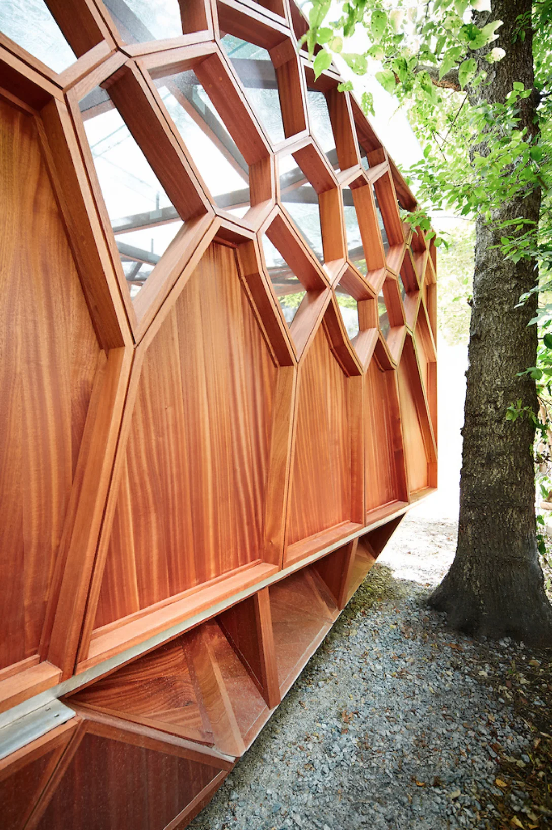 Designed to be a private open air retreat, the pavilion features an integrated bench, a glass roof to protect from inclement weather, and is fully screened to defend against insects.