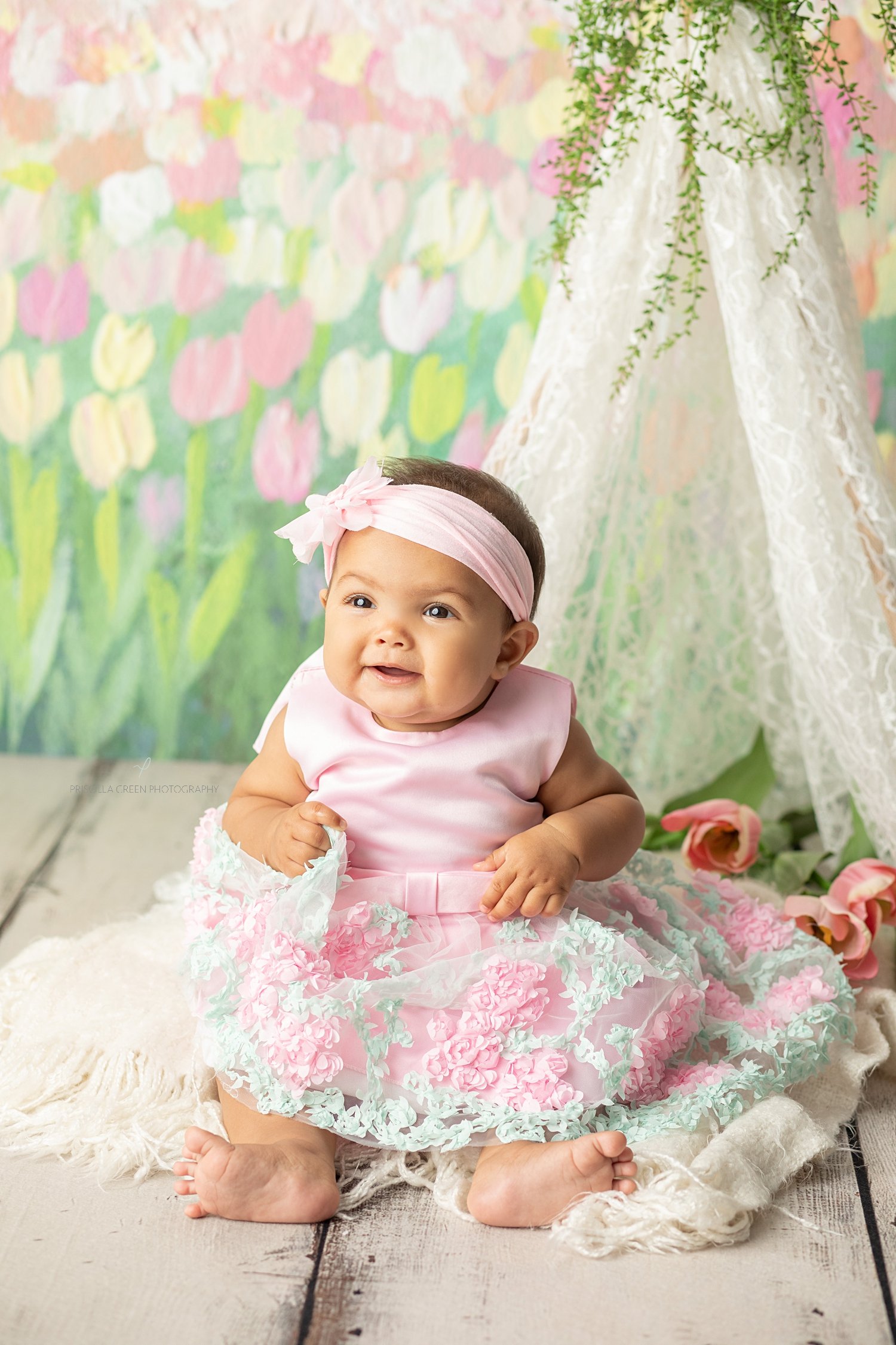 baby girl with flowers and teepee