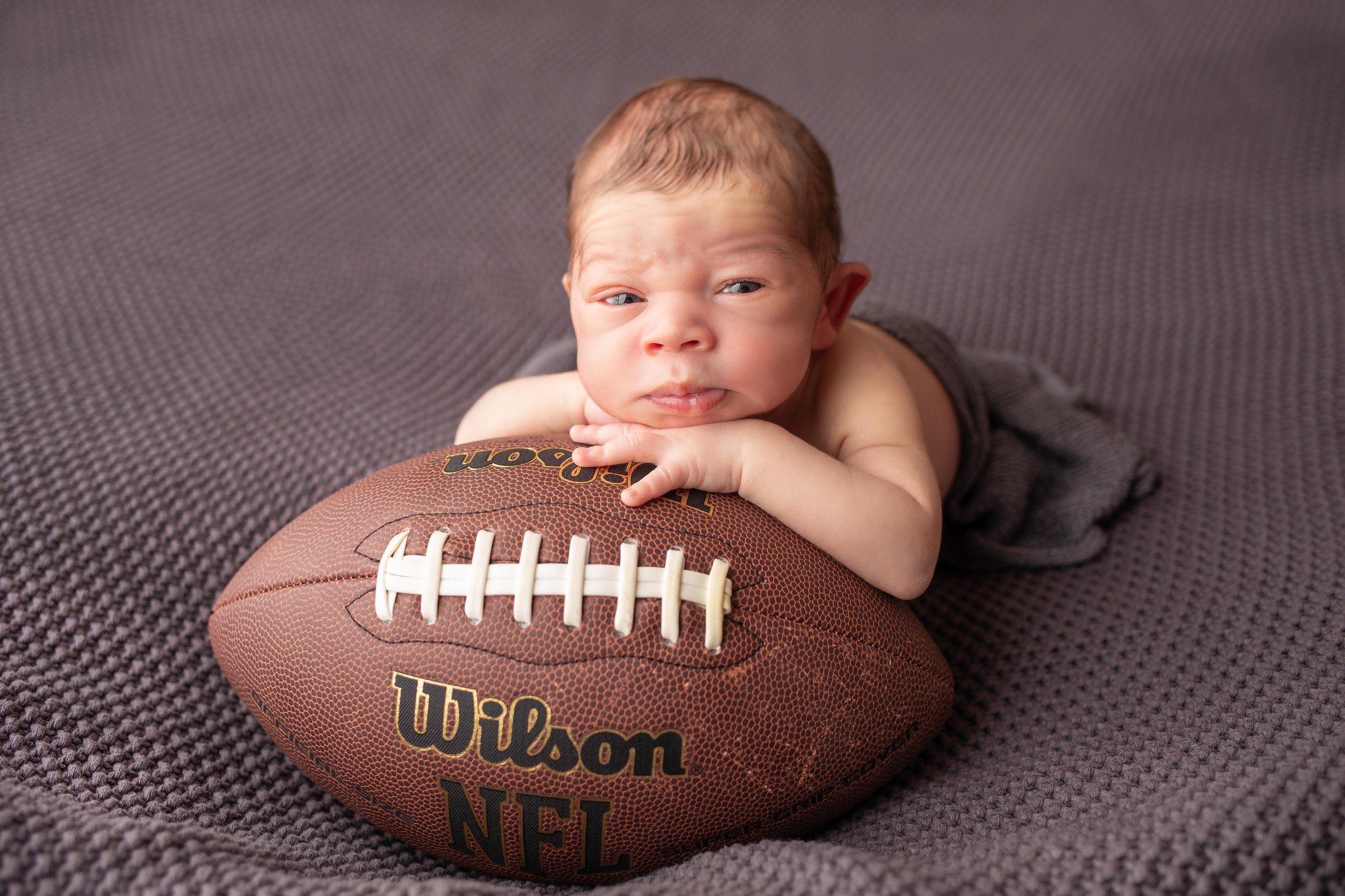Newborn photoshoot in Charlotte, nc with football