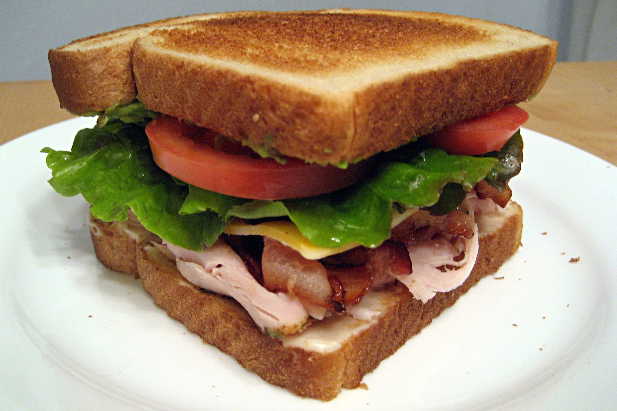 TURKEY CLUB SANDWICH Lettuce, Tomato, Onion, Bacon & Cheese.