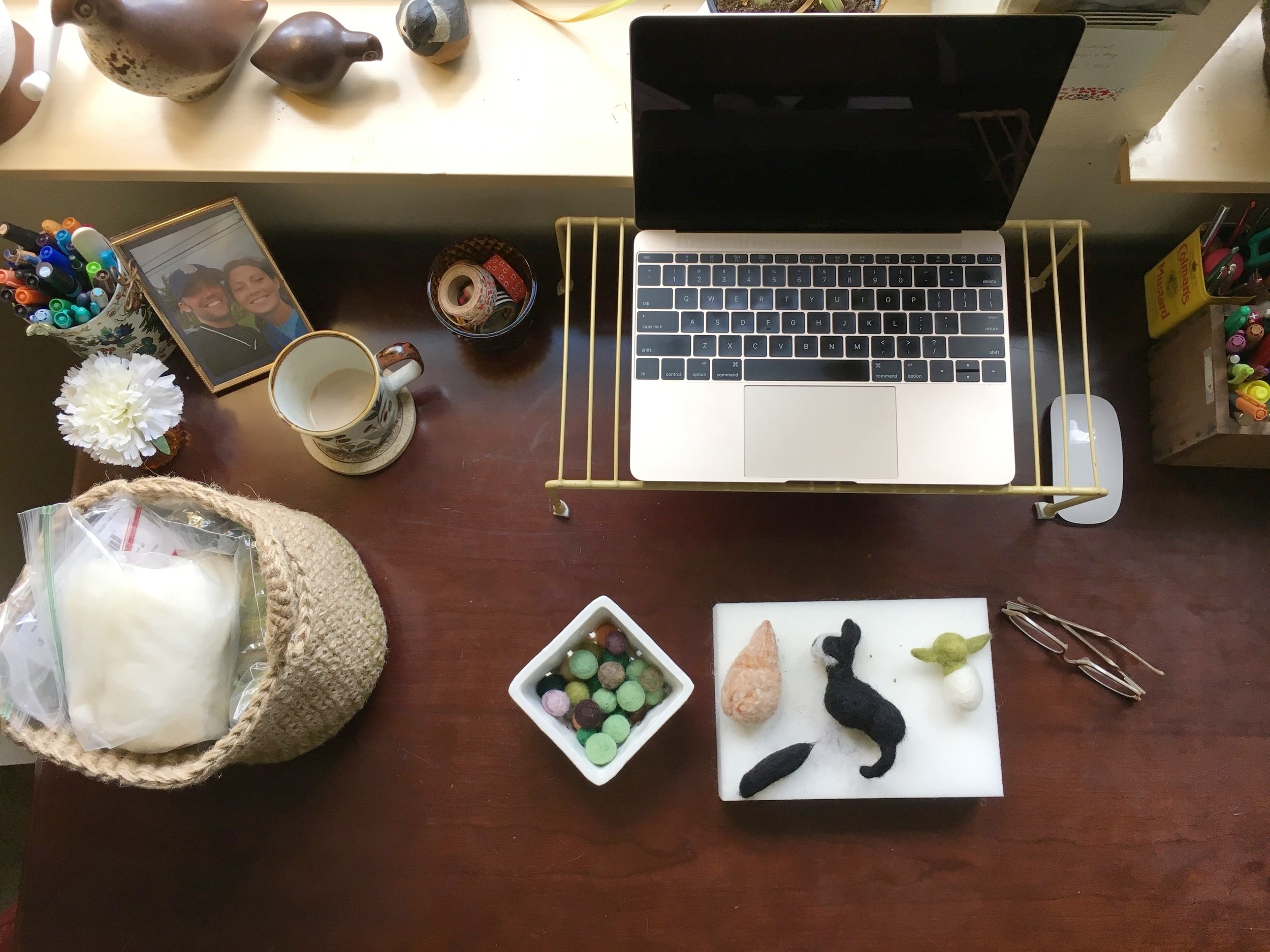 When I'm working on a felting project, my desk space looks like this. I keep my computer out tolook at different angles of whatever animal or plant or other item I'm felting in 3-D. And I always work with coffee.