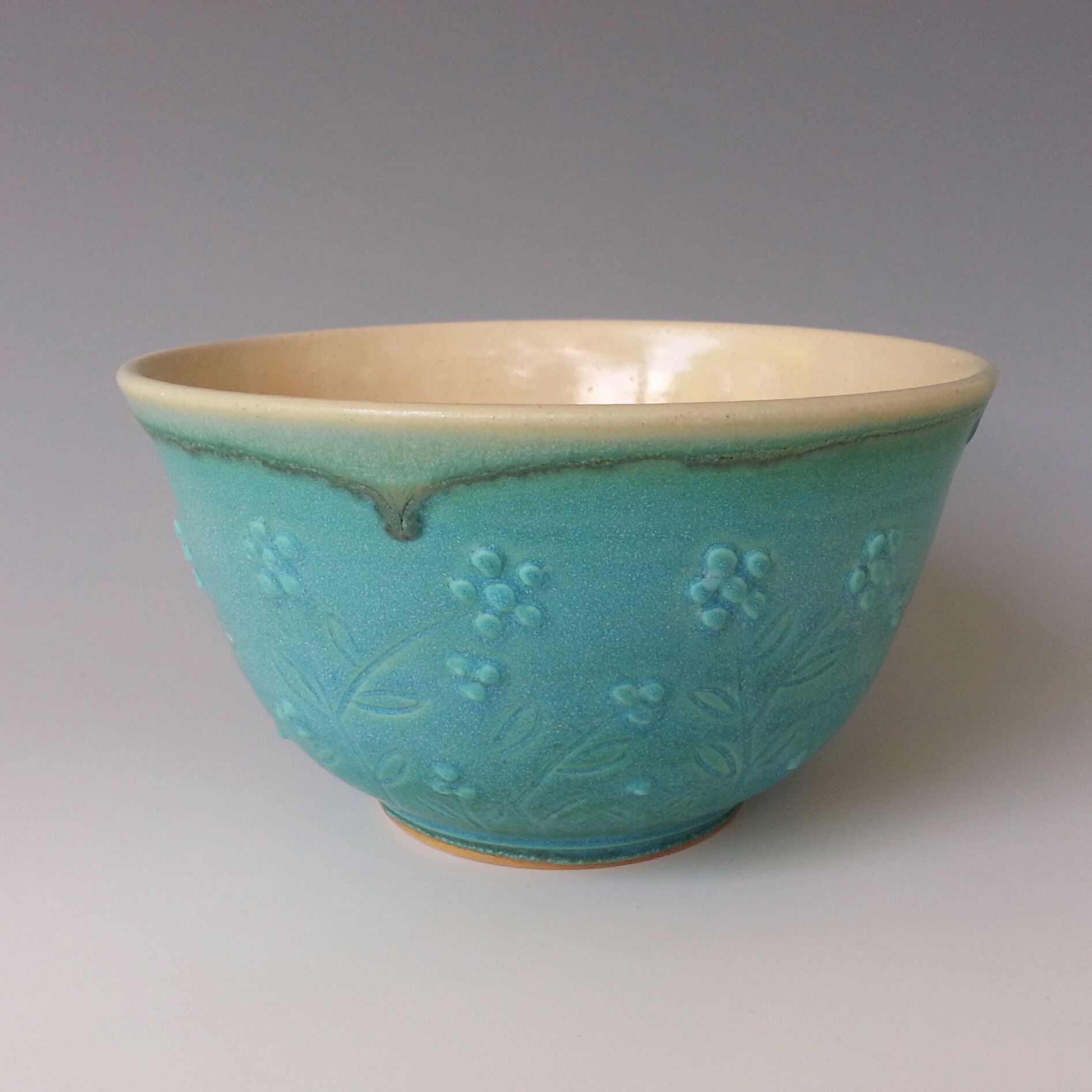 small turquoise bowl, carved and slip-dotted