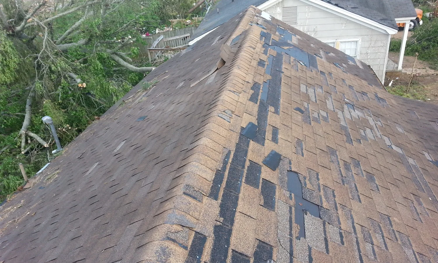 Wind damaged roof shingles