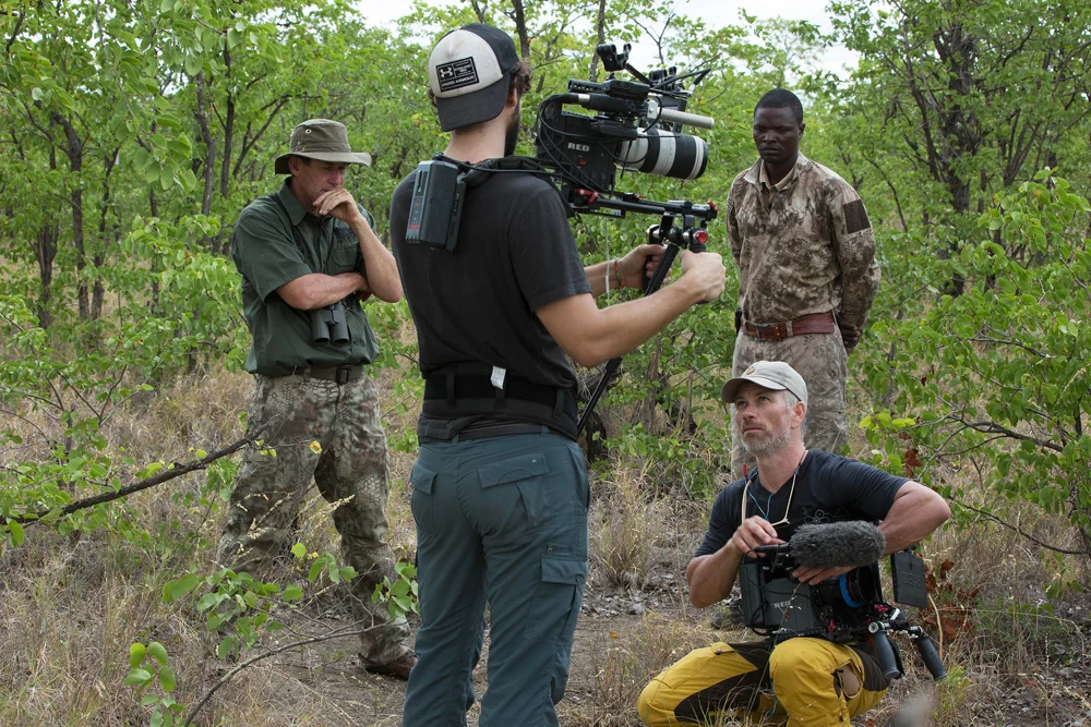 Me Branlin Shockey Steve Best and Big Livi trying to work out how to move among a herd of elephant bulls with all our equipment in thick mopane woodland