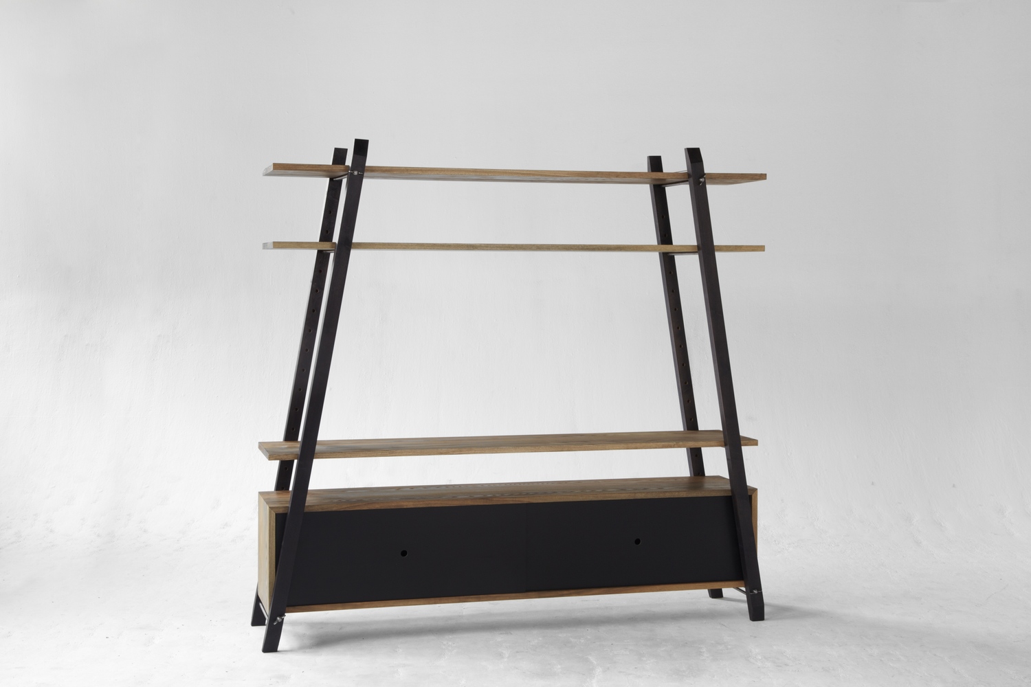 The Fisk shelving system can be configured as a media center with the available enclosed case. Shown here in solid ash & walnut with lacquered sliding doors.