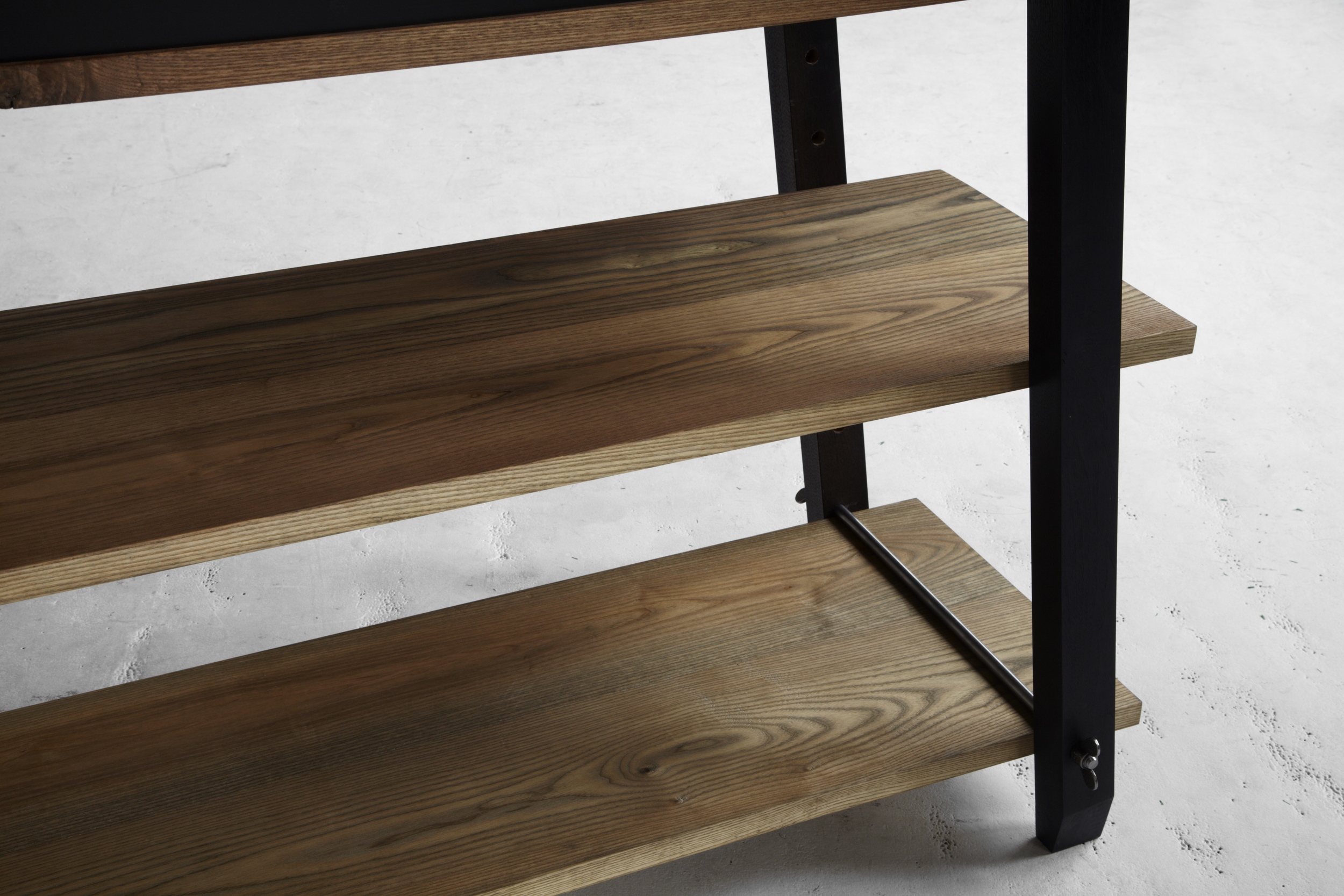 The rich patina is achieved by oxidizing the wood's natural tannins with vinegar and iron. This centuries-old technique turns the walnut a deep ebony and brings out shades of amber, gold & green from the white ash, which vary from board to board.
