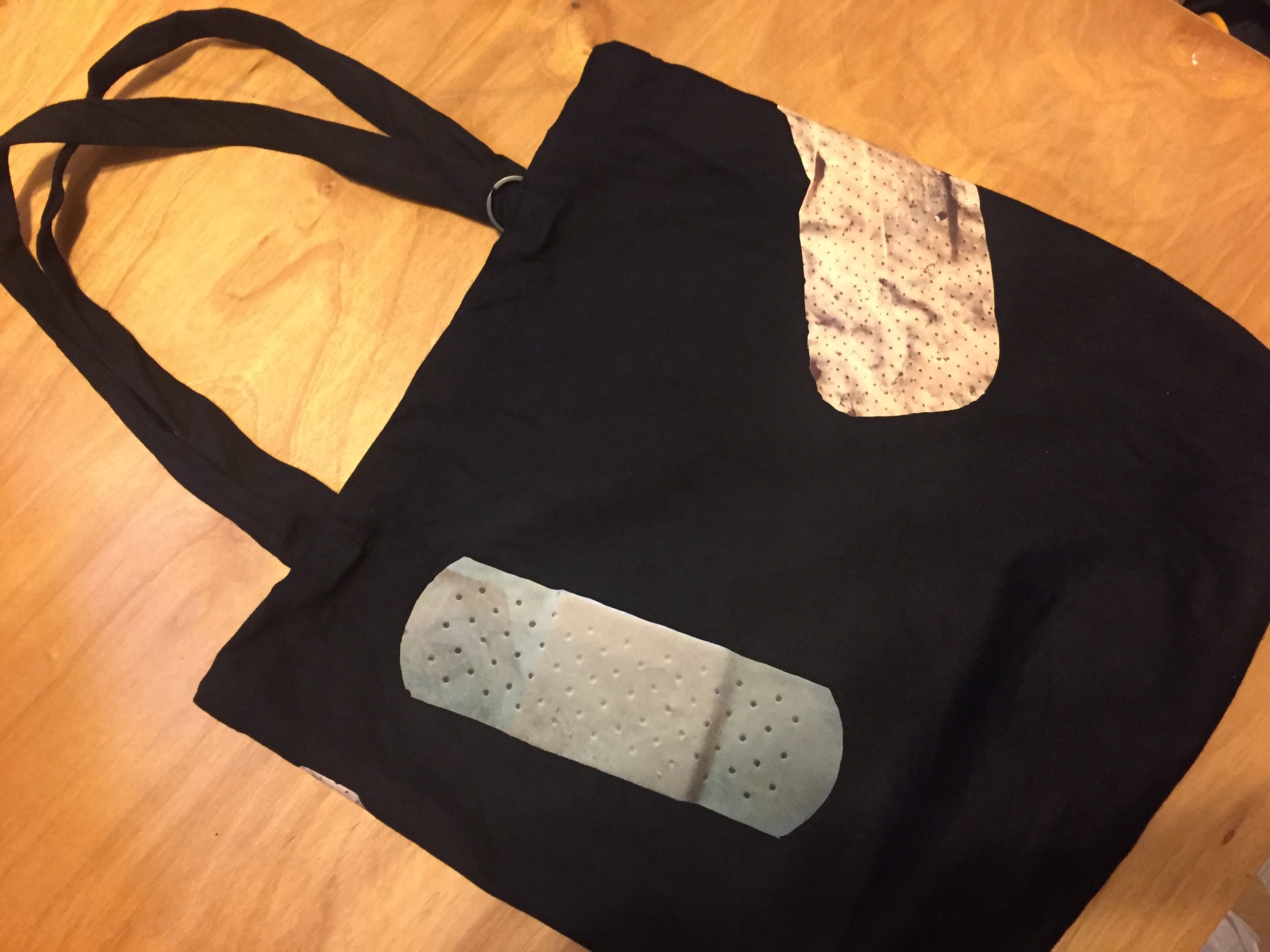 Bandage Tote Bag. Iron-oned, Pre-washed, Preshrunk. 10oz 100% Cotton canvas. 15” x 15” x 4”. Each Bandage was documented on the street using cellphone camera by Niizeki Hiromi. 
