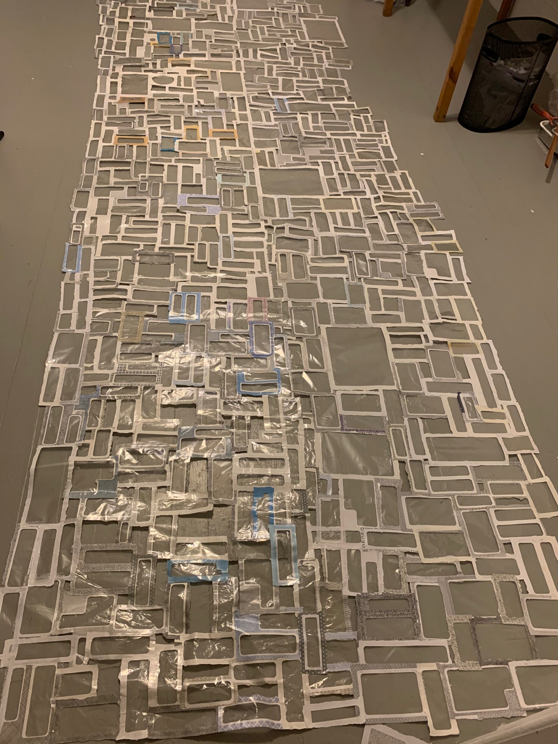 Windows from donated used window envelopes were connected together after tore.