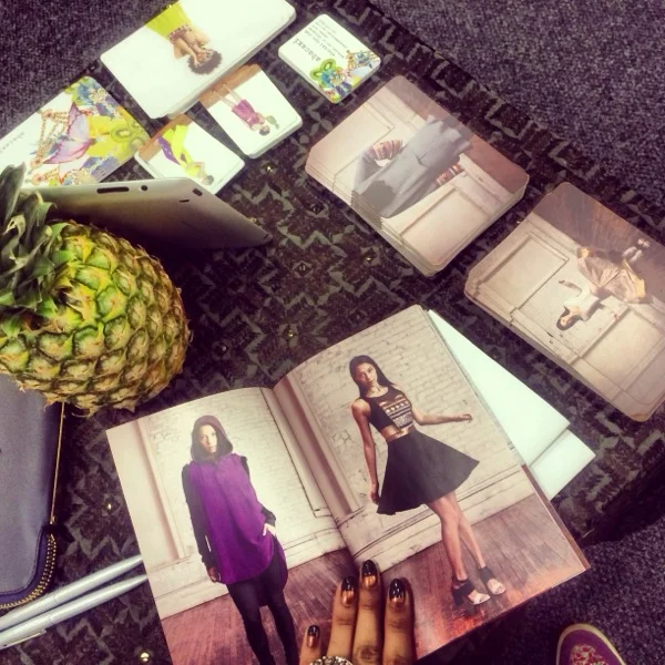 Lookbooks, postcards, and a pineapple centerpiece at our booth. 