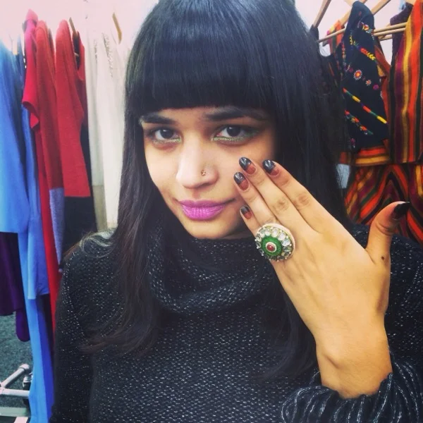 Strong Lips, Eyes, and Nails on the first day of the show, in the Crop Fringe Cable Sweater. 