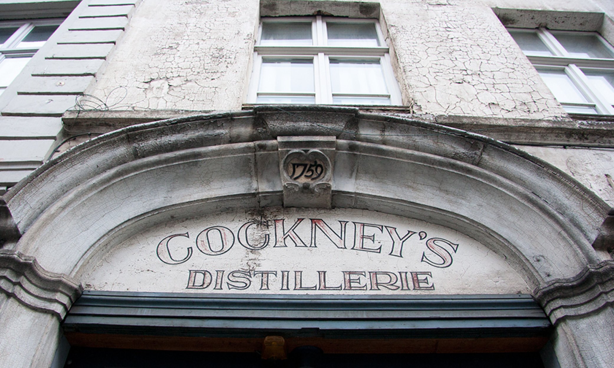Type Walk in Ghent. Before &amp; After. Looking up: the fading letters of Cockney's Distillery.