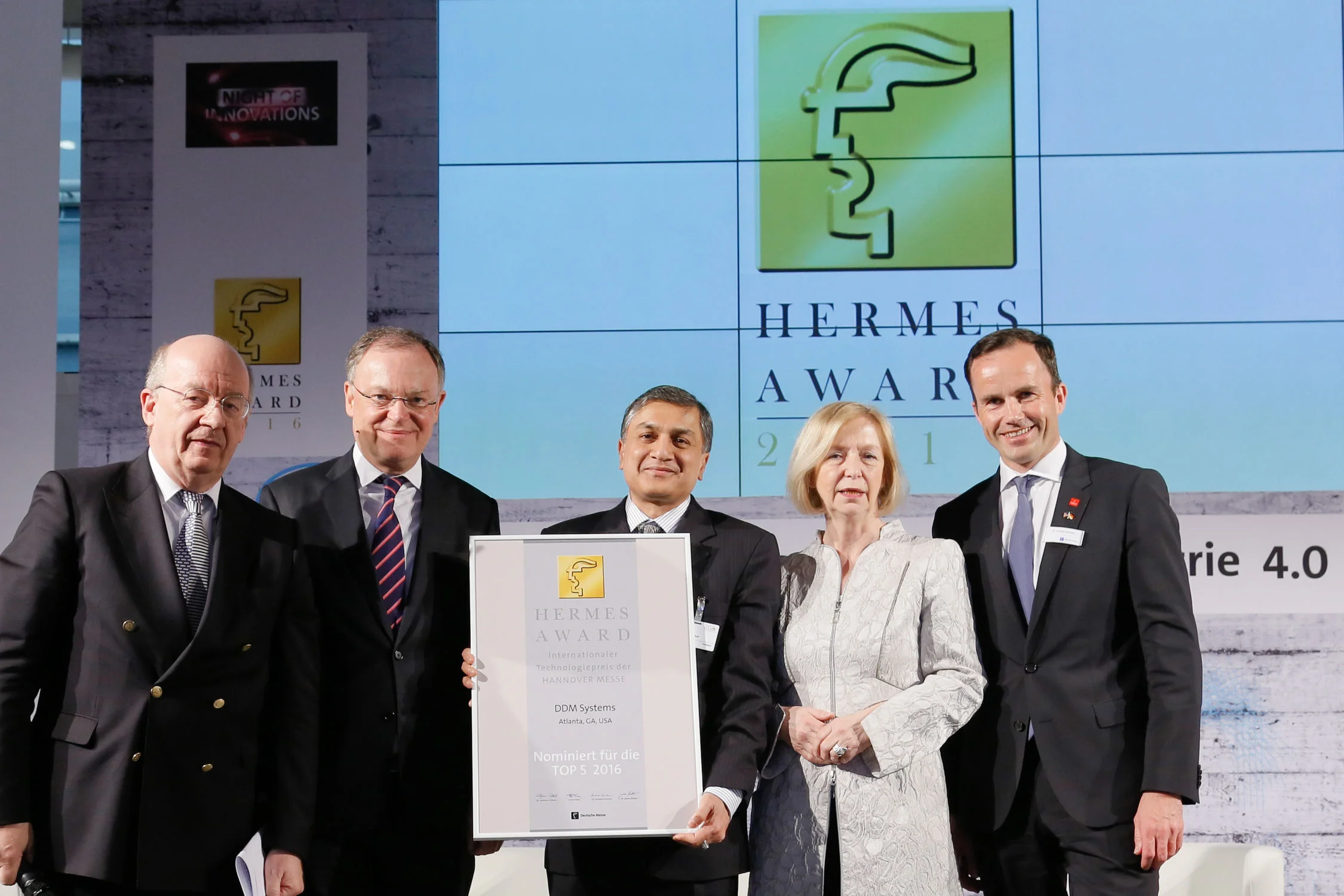 From Left to Right, Prof. Dr. Wolfgang Wahlster, Head of the HERMES award Jury, Chairman of the Board of the German Research Center for Artificial Intelligence, Stephan Weil, Minister President of Lower Saxony (Niedersächsischer Ministerpräsident), Dr. Suman Das, Prof. Dr. Johanna Wanka, German Federal Minister for Education and Research, and Dr. Jochen Köckler, Member of the Managing Board of Deutsche Messe, Hannover, Germany