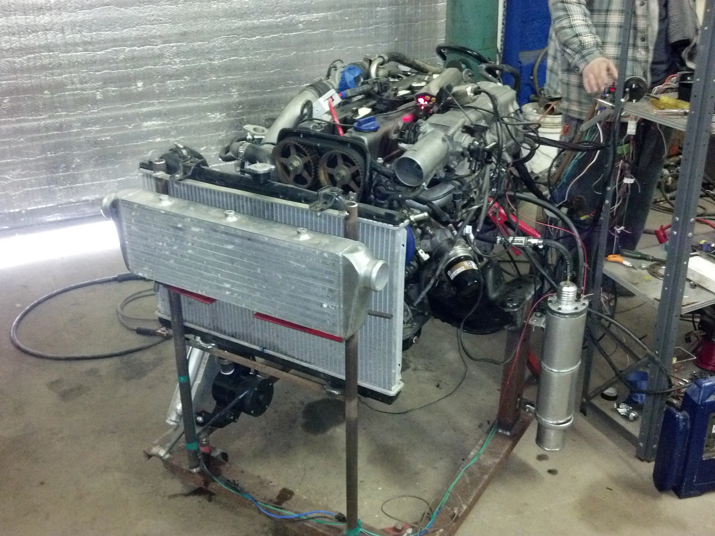 Home made engine test stand. Yes that is a efi fuel tank made from alum exhaust parts. Note small block Chevy electric water pump for circulation. AEM wideband coupled to Tuner Studio. 