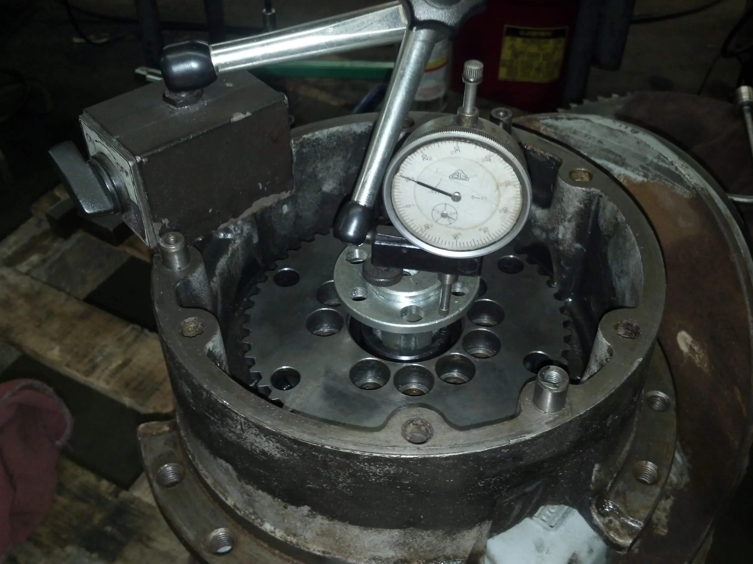 This is wheel "pod". Originally a 72 V DC motor located on the back side of this pod drove a planetary gear system in this hub. The actual wheel and urethane tire bolts on to the outer flange. What you see now is a 6 spline stub shaft inserted in a hub city coupler which in turn couples directly to the 1" keyed shaft of a hydraulic motor.