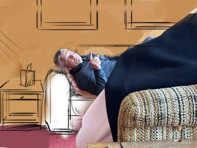And now Michael, lying on a proper therapist’s couch, with two pieces of art hanging above the couch. And, of course, a side table with a box of TISSUE on it.