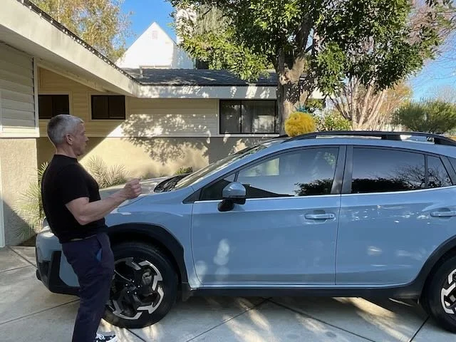  …and landing with a THUD on another car, in another driveway, shocking a NEIGHBOR who’s in the middle of washing his car… 