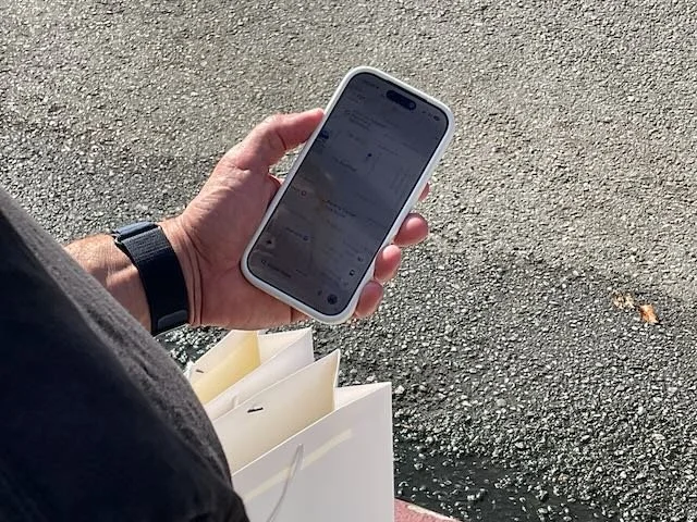  A CLOSE-UP of the HUSBAND requesting a ZOOX. 