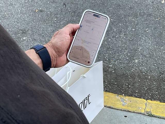  A CLOSE-UP of the HUSBAND requesting a ZOOX. 