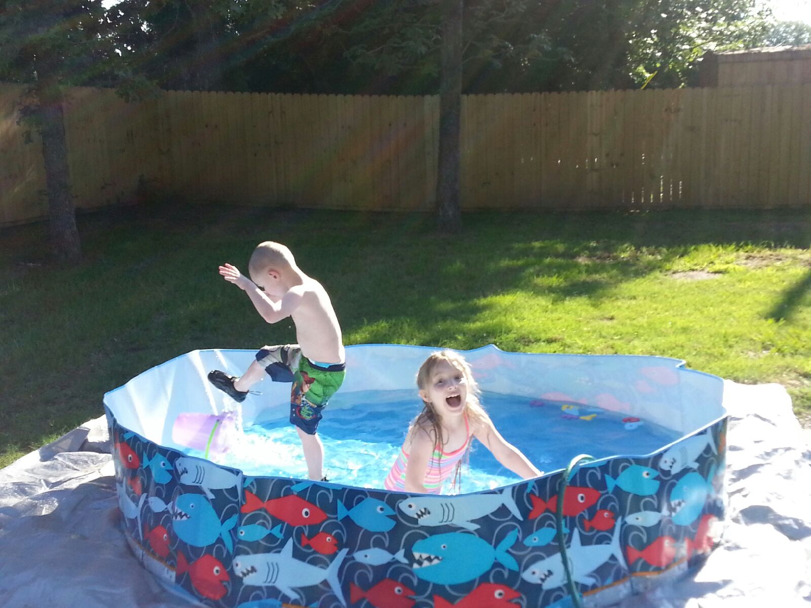 Grace and Ezra in their "making memories" kiddie pool. I would love to have taken a picture of Ezra in his mud puddle for you all, but every time I got near the puddle he would pull me back down into it!