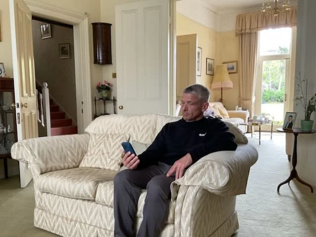  CUT…to the 70-year-old WOMAN, sitting on her LIVING ROOM COUCH, admiring the PHONE.    VO:  “In fact, we don’t just promise…”  