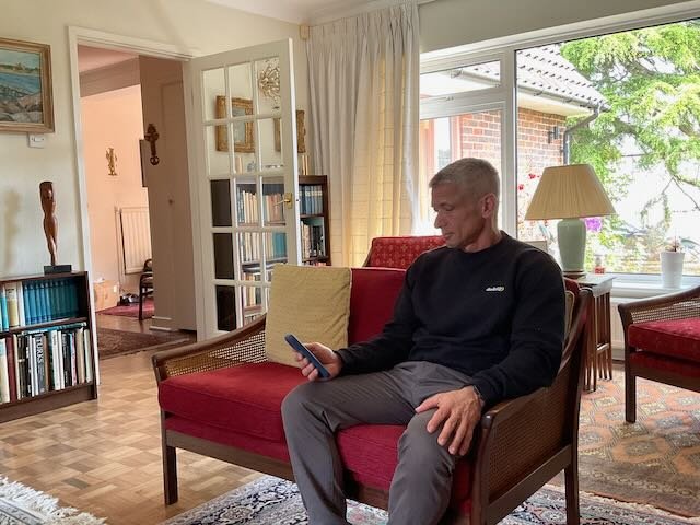  CUT…to the 70-year-old WOMAN, sitting on her LIVING ROOM COUCH, admiring the PHONE.    VO:  “In fact, we don’t just promise…”    